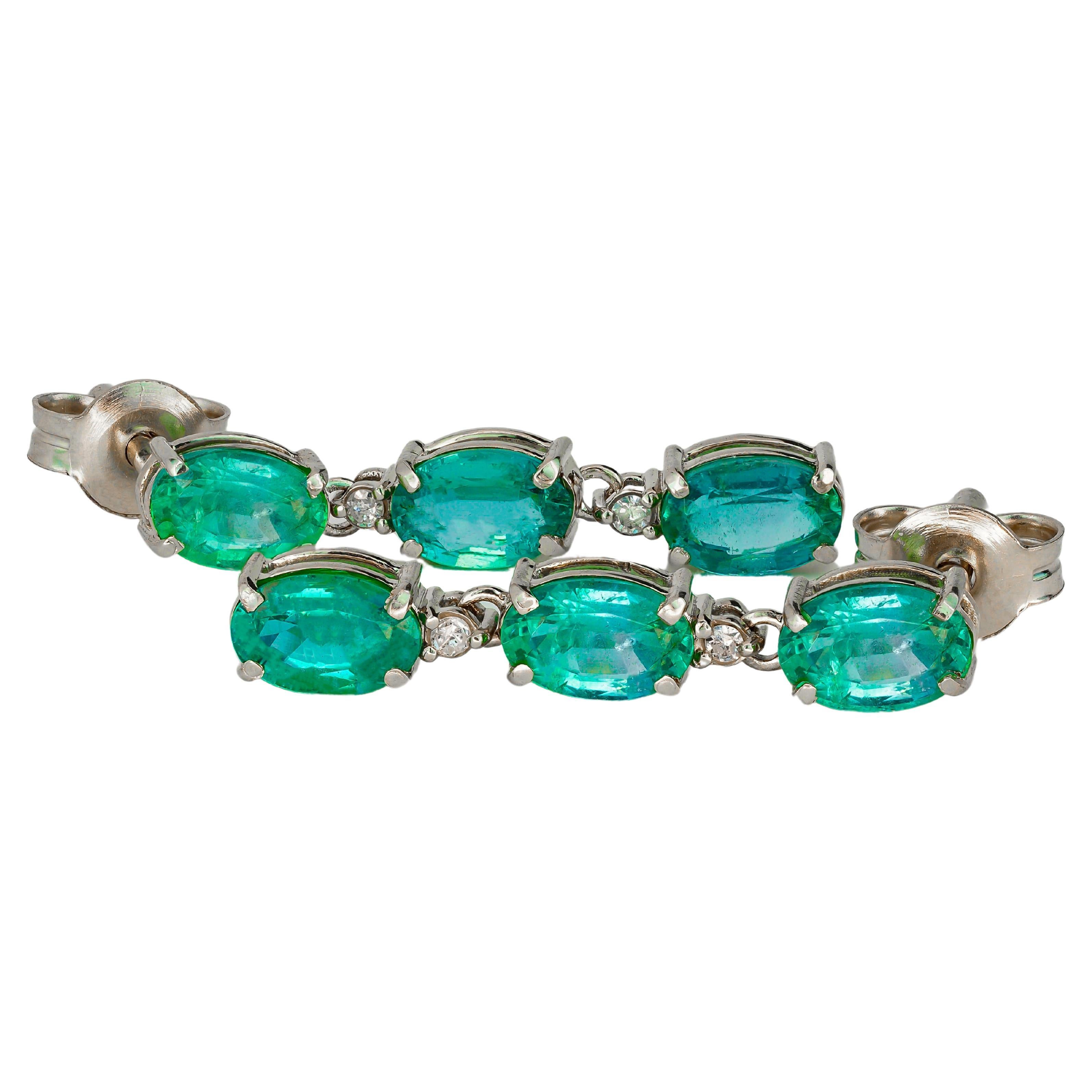 Oval emeralds 14k gold earrings studs.  For Sale