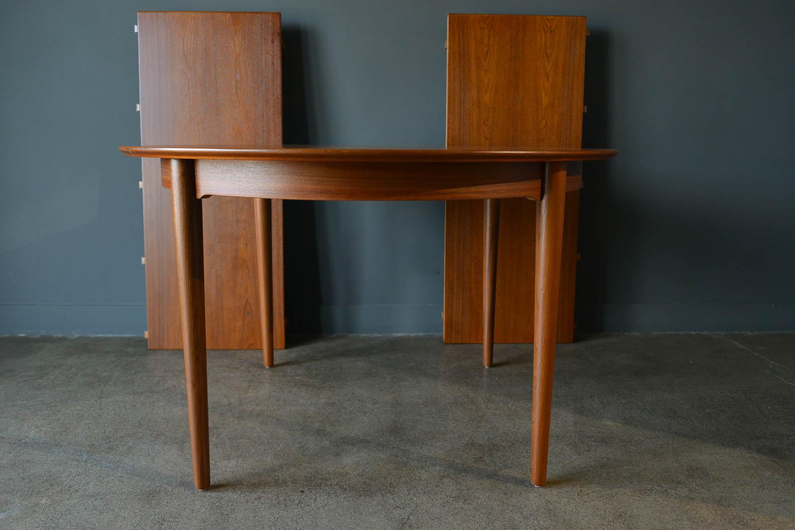 Teak expandable dining table by Niels Moller, circa 1960. Includes two matching leaves when inserted can seat 8 comfortably in an oval shape. Compact design allows for a round table that seats 4. Professionally restored in perfect condition, this