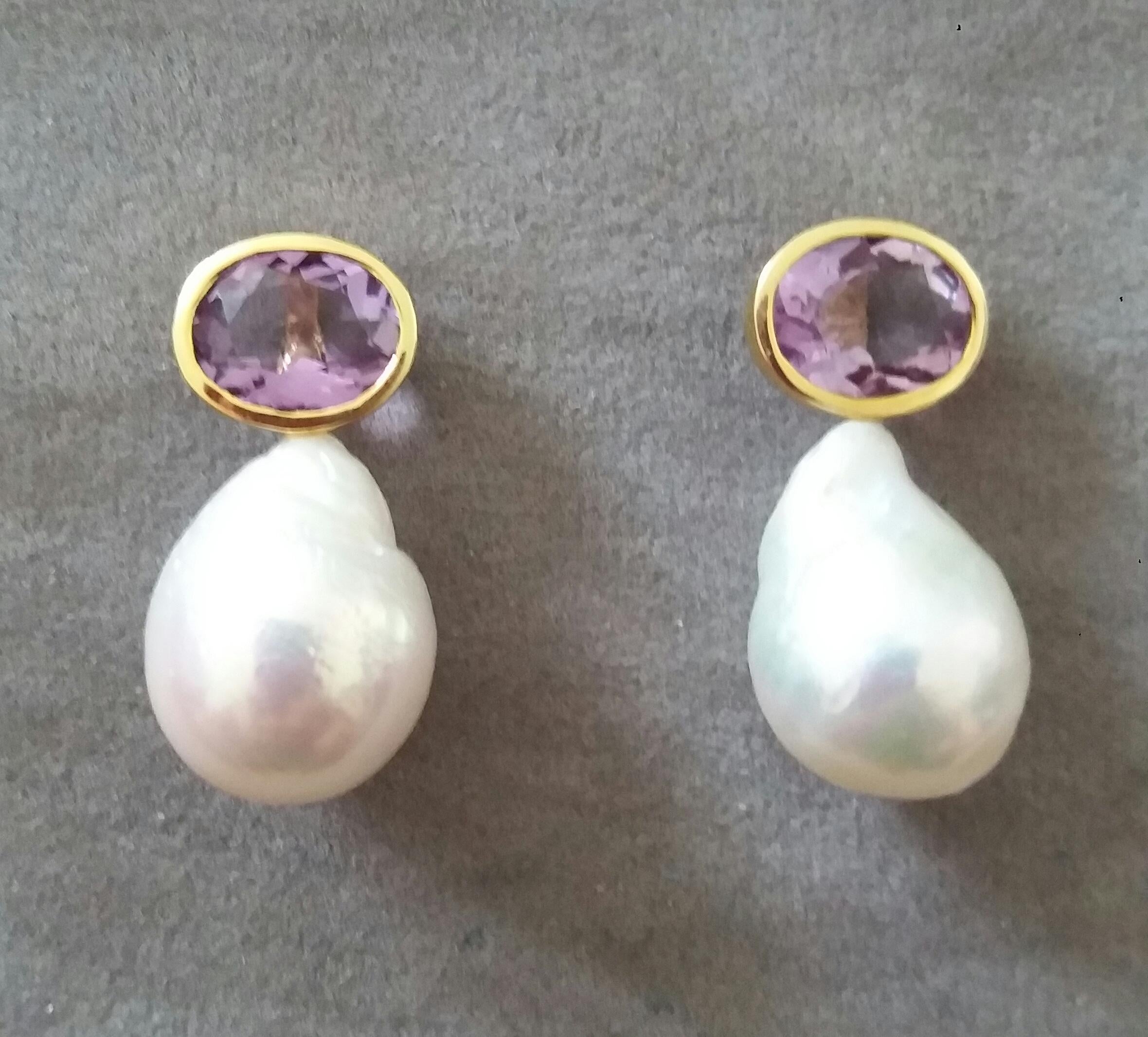 These simple but elegant earrings have 2 faceted Oval Shape Natural Amethysts size 8x10 mm set in yellow gold bezel at the top to which are suspended 2 Pear Shape White Baroque Pearls measuring 13mmx17mm and weighing 36 carats

In 1978 our workshop