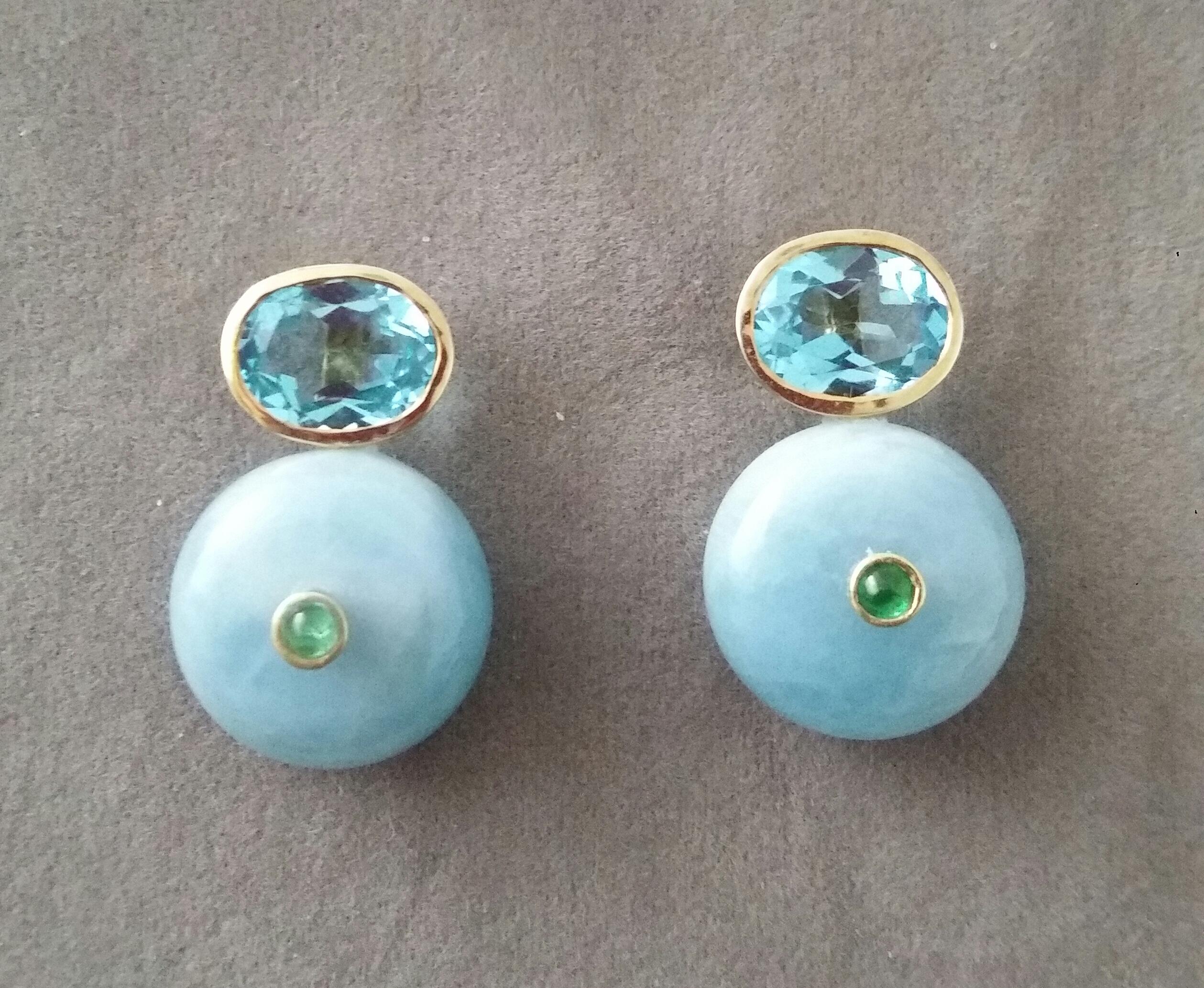 Simple chic stud earrings with a pair of Oval Cut Blue Topaz measuring 8mm x10 mm set in solid 14 Kt. yellow gold on the top and in the lower parts 2 Round Plain Wheel Shape Aquamarine  16 mm .in diameter with a small round Emerald cab in the