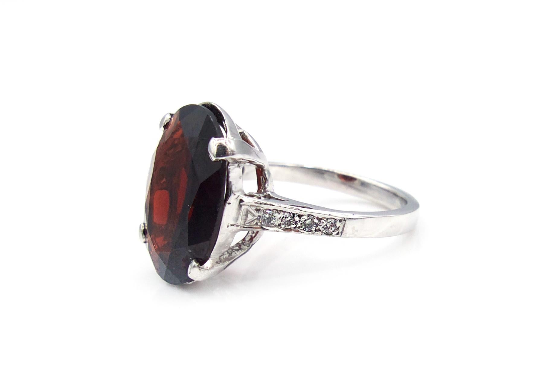 This 6 carat oval faceted garnet is prong set in a 14K white gold band and flanked by 8 bright white round cut diamonds.

5.2 g

Size 6.5

