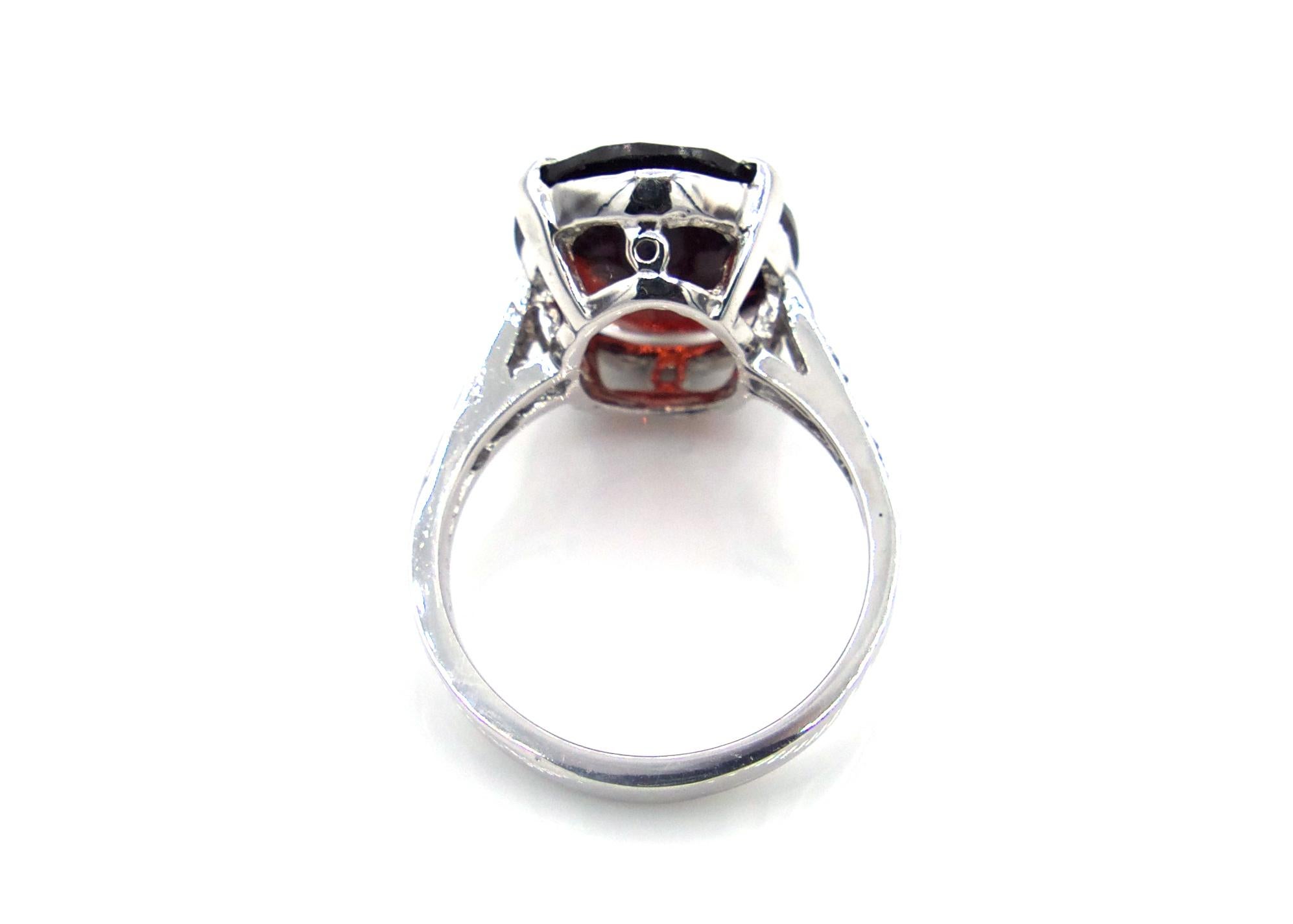 Contemporary Oval Faceted Garnet and Diamond Ring For Sale