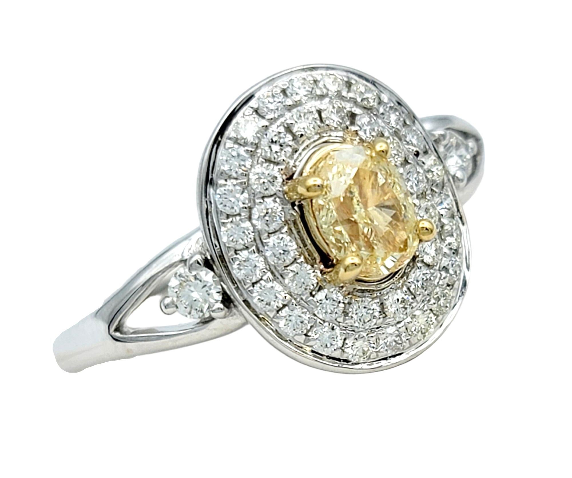 Ring Size: 7.25

Embrace unparalleled elegance with this enchanting 14 karat white gold ring, adorned with a captivating oval-cut fancy yellow diamond at its heart. Encircling the radiant centerpiece is a double row clustered pave diamond halo,