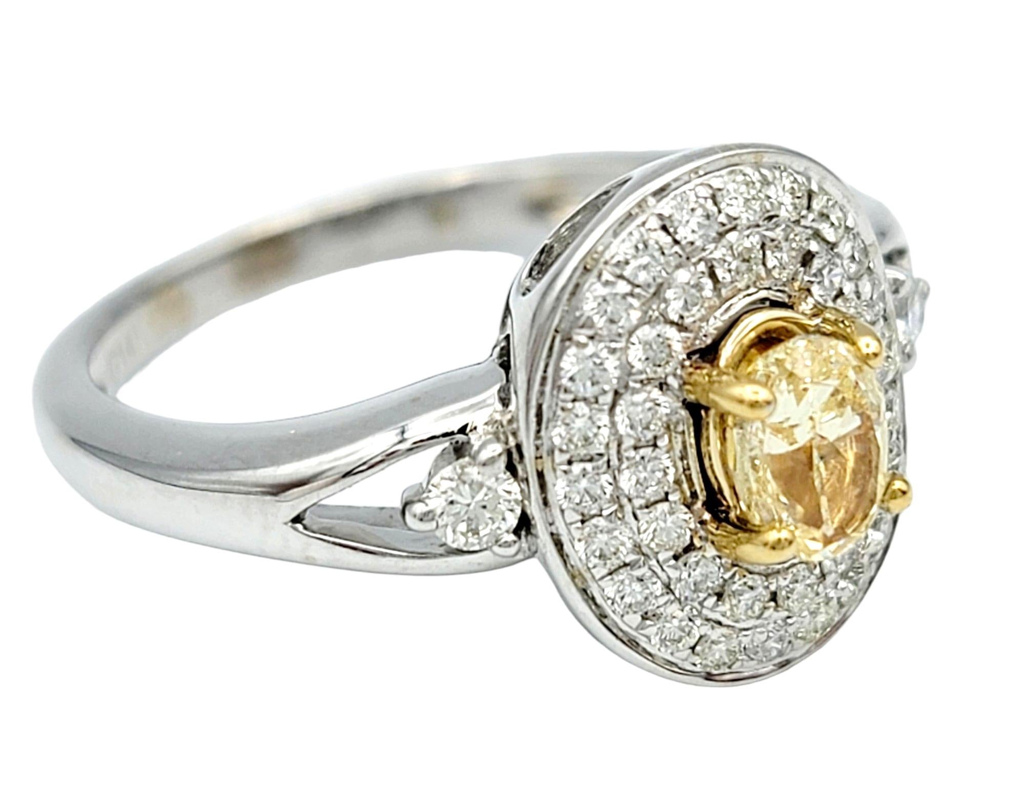 Contemporary Oval Fancy Yellow Diamond with White Diamond Double Halo Set in White Gold For Sale