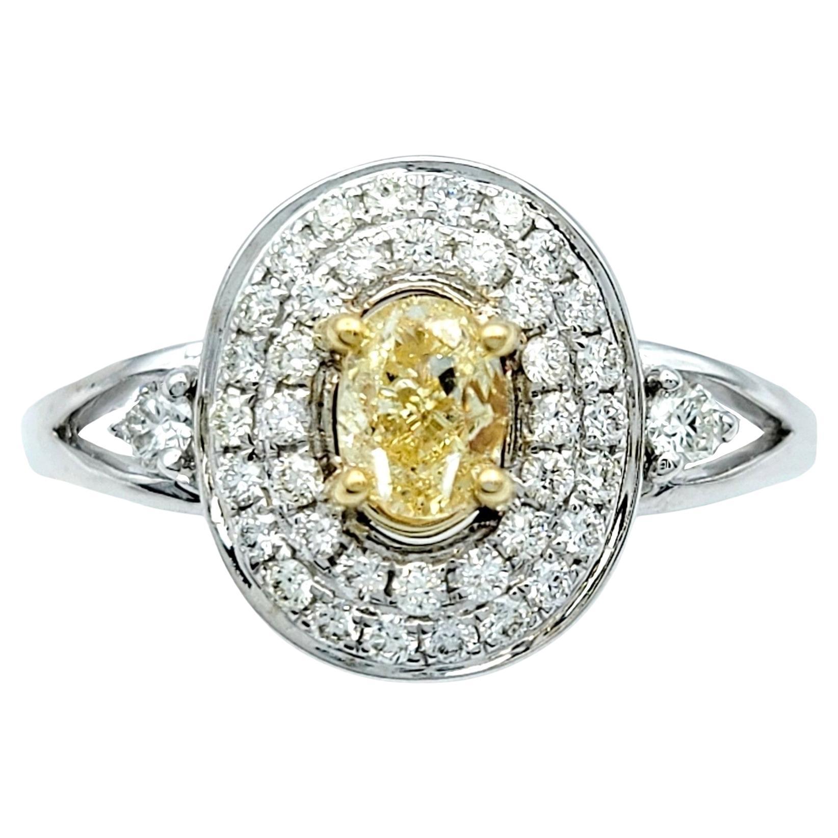 Oval Fancy Yellow Diamond with White Diamond Double Halo Set in White Gold For Sale