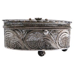 Oval filigree silver jewelry box on four feet with hinged lid