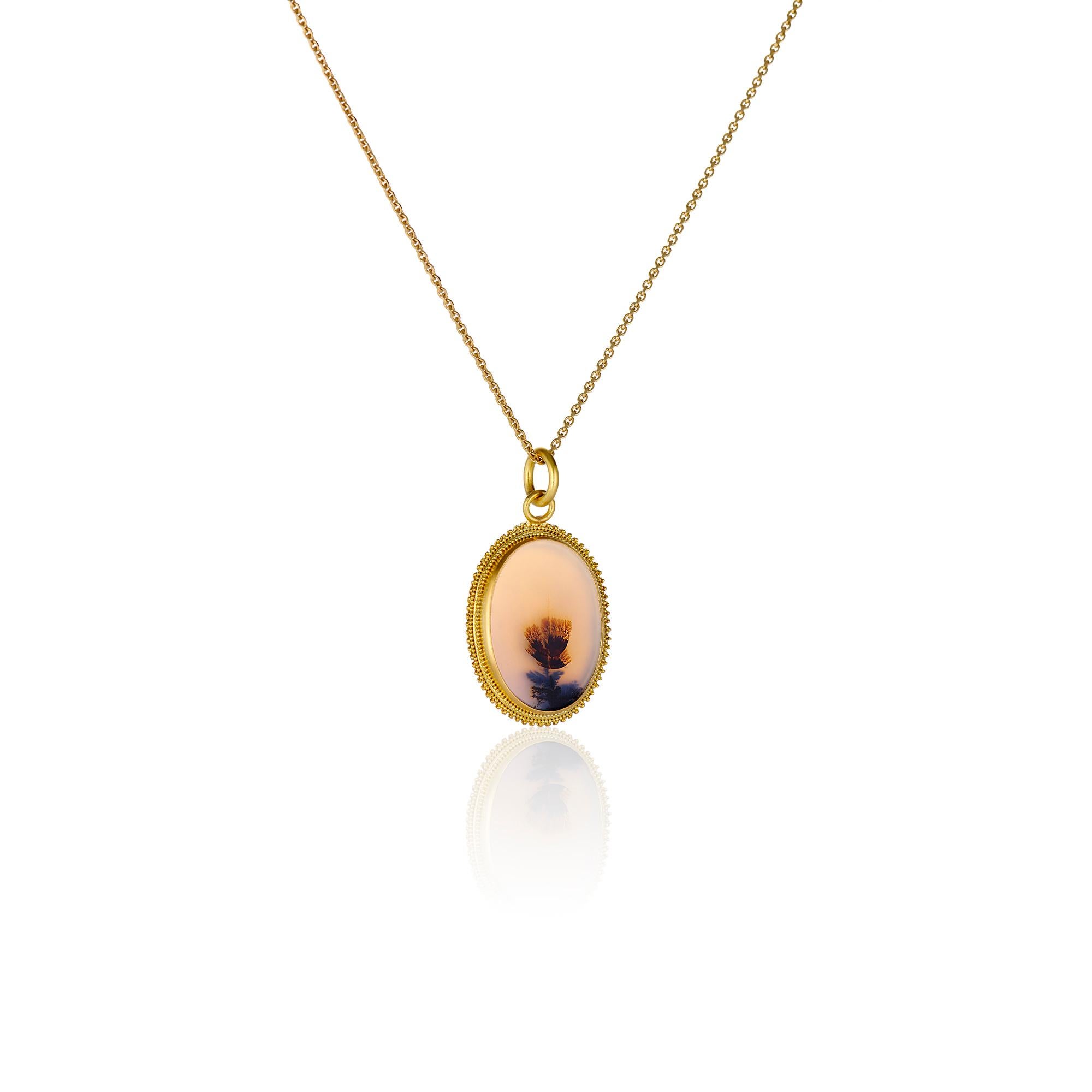 Romantic with a nod to Victorian sensibility, this beautiful ivory, mustard and black floral oval dendrite agate is 1.38 inches in length and 1 inch in diameter.  The dendritic agate is encased in a bezel of warm 22 karat yellow gold with 22 karat