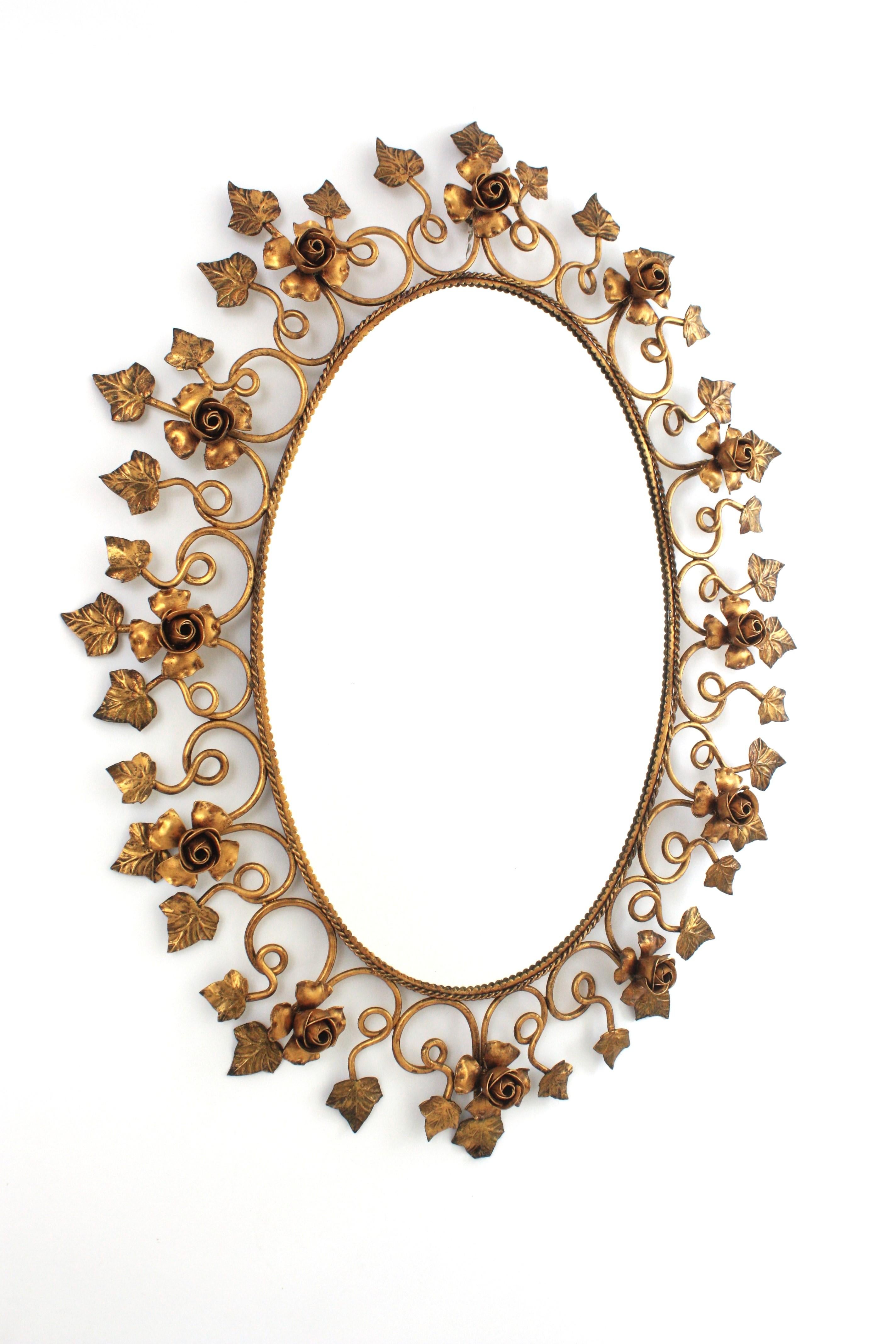 Spanish Oval Foliage Wall Mirror with Flower Accents
Hollywood Regency gilt iron oval mirror framed by a decoration of roses and leaves, Spain, 1950s.
This mirror has a finely handcrafted work and its detailed frame is highly decorative.
It will be