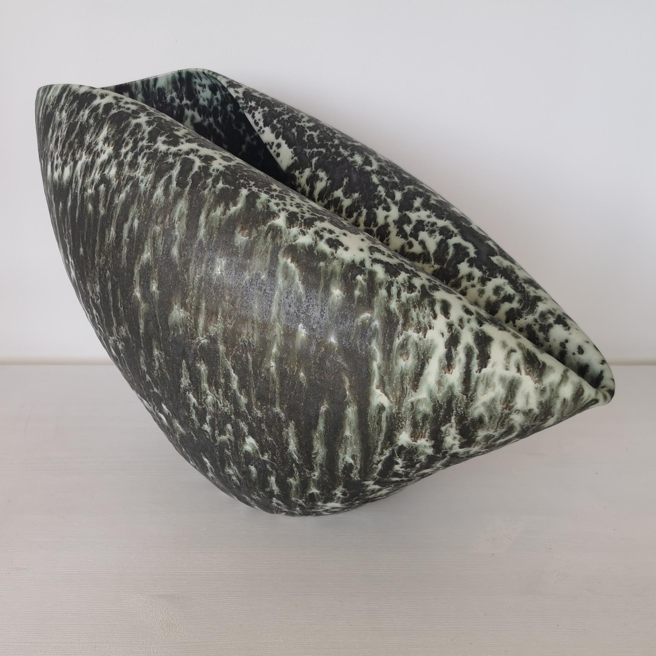 Vessel from ceramic artist Nicholas Arroyave-Portela.

No. 98 Medium long Oval form with a green and black speckled glaze (Vessel, Interior sculpture, not suitable for holding water)

White St.Thomas clay, Stoneware glazes, multi fired to cone 6