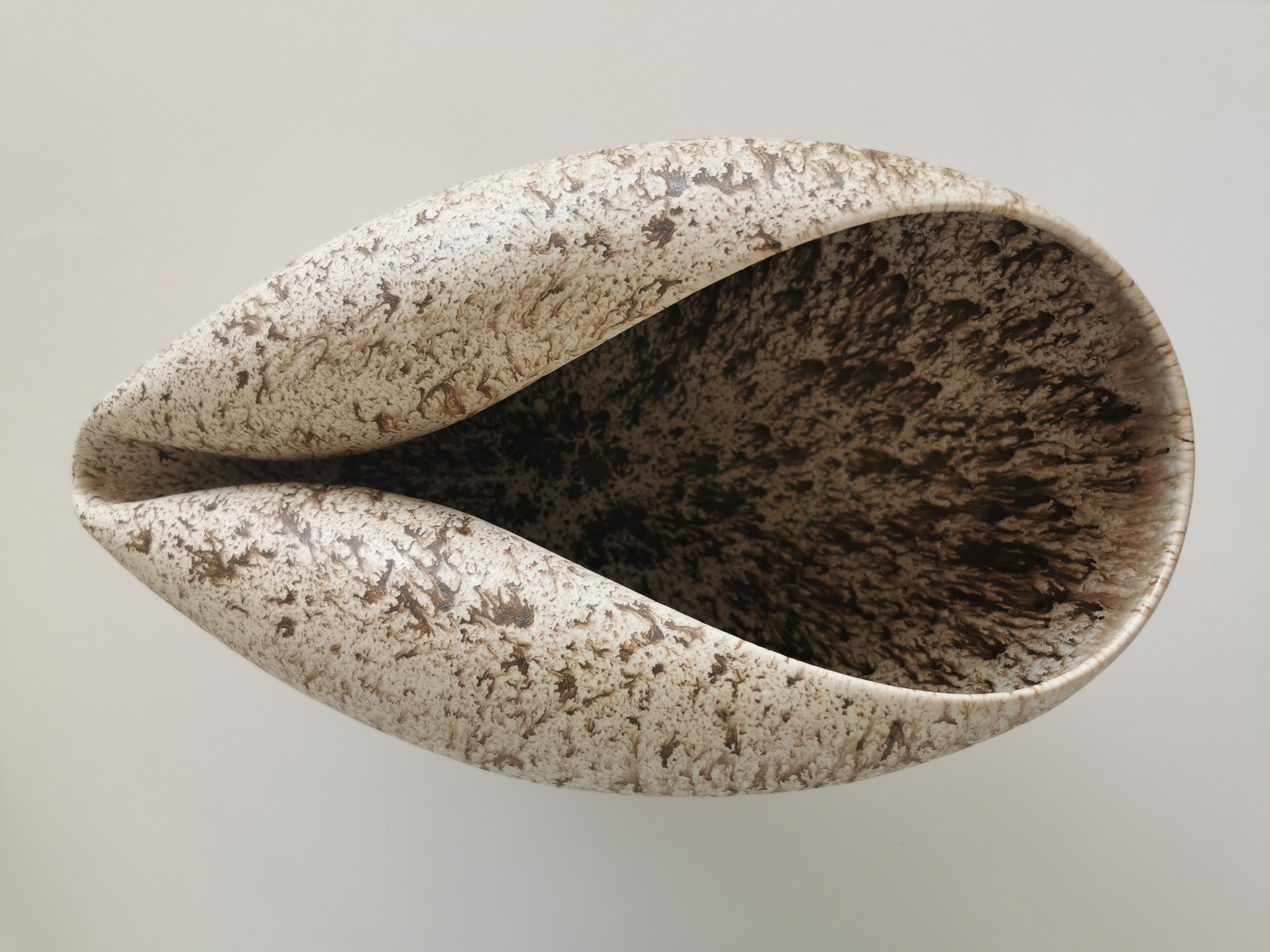 Vessel from ceramic artist Nicholas Arroyave-Portela.

No. 99 Medium long Oval form with a white and brown speckled glaze (Vessel, Interior sculpture, not suitable for holding water)

White St.Thomas clay, Stoneware glazes, multi fired to cone 6