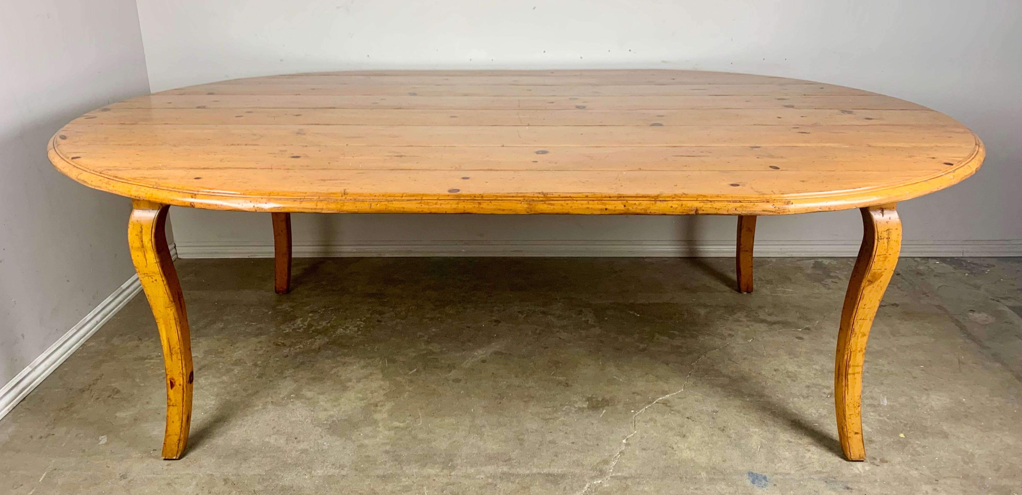 Oval French country style dining table with single leaf. The pine table stands on four cabriole legs. Unique leaf extension that adds to one side of the table. This table has simple but elegant lines and will work with many decors.

Size of table