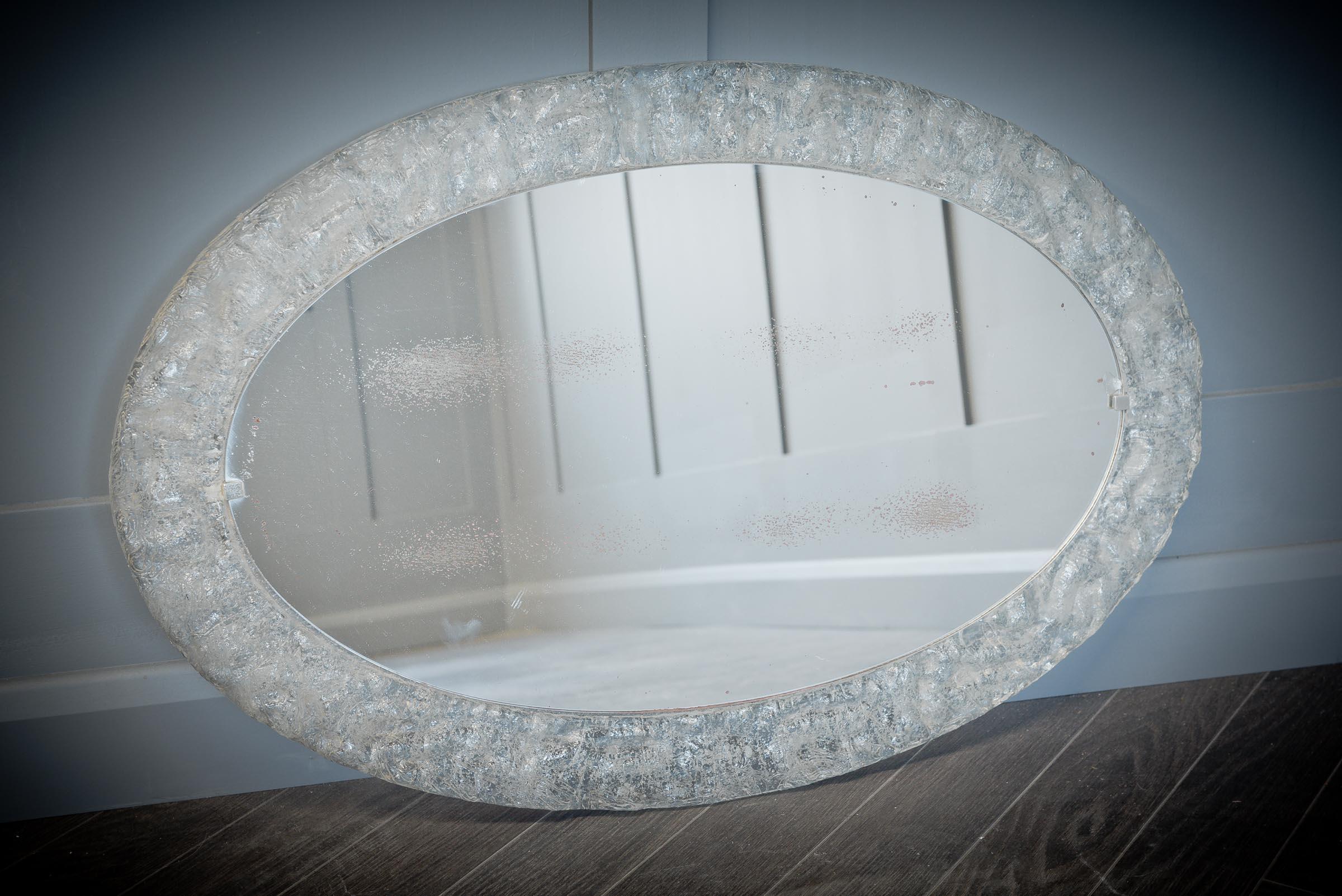 This stunning oval frosted glass mirror is typical of mid-century style and would look beautiful in a hall or above a dressing table.