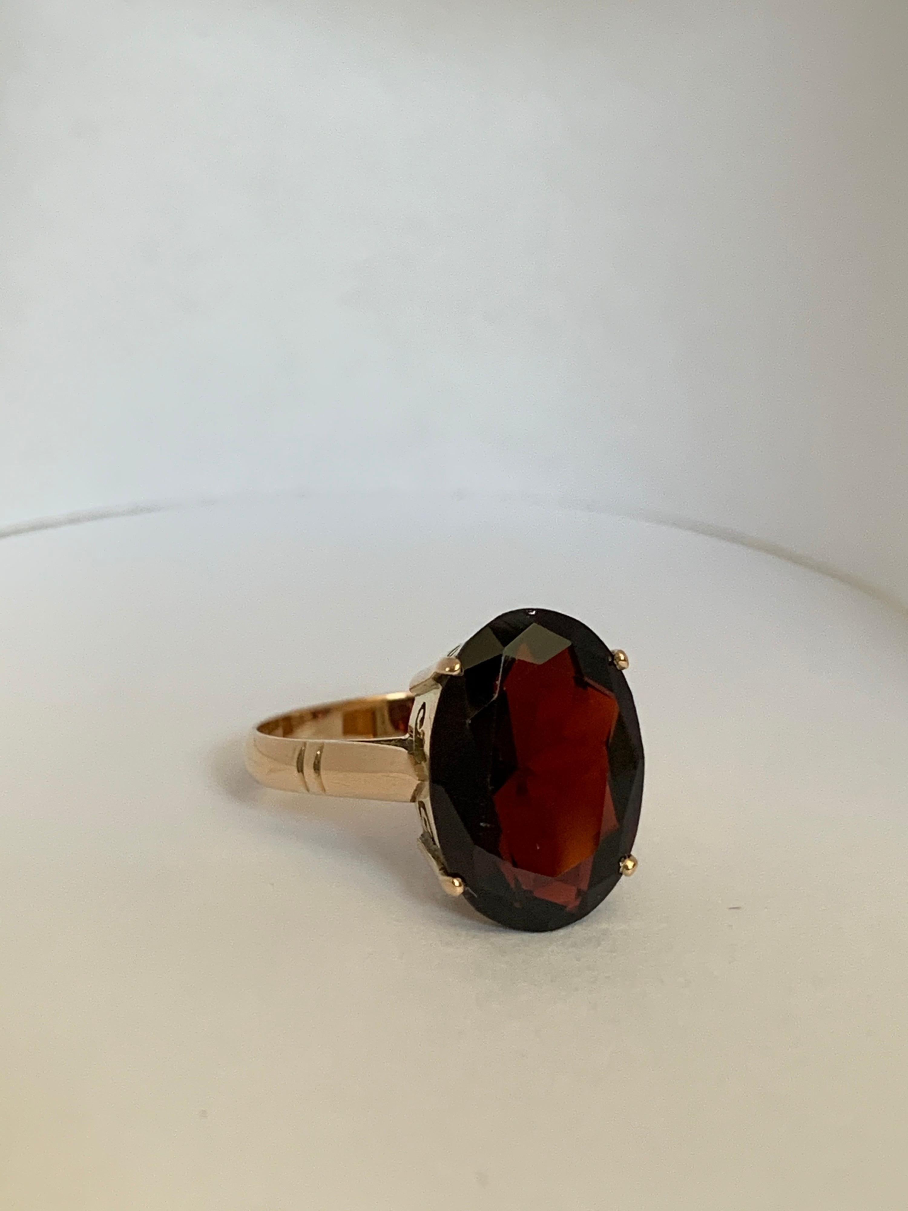 Contemporary Oval Garnet Set in 14 Karat Yellow Gold Ring For Sale