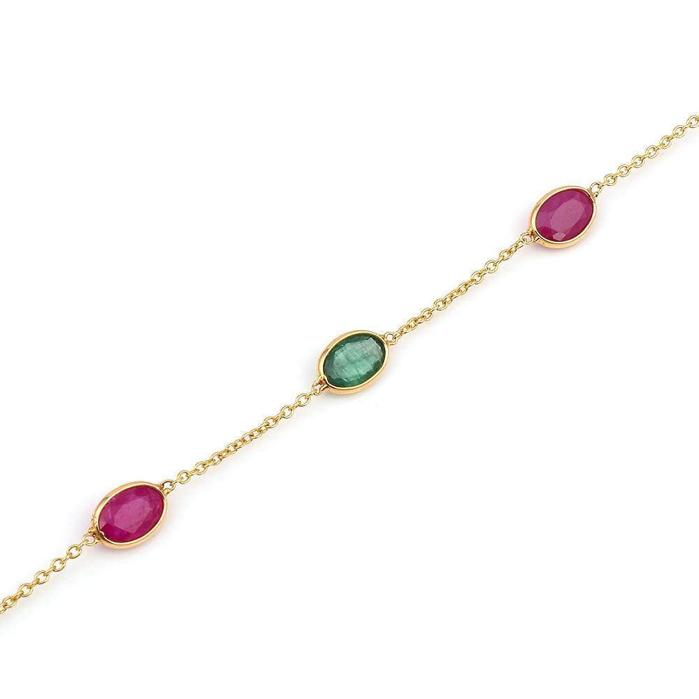 A 4 x 6MM Oval Genuine Ruby and Emerald in 18k Yellow Gold Adjustable Bracelet. The length of the bracelet is 7.75.