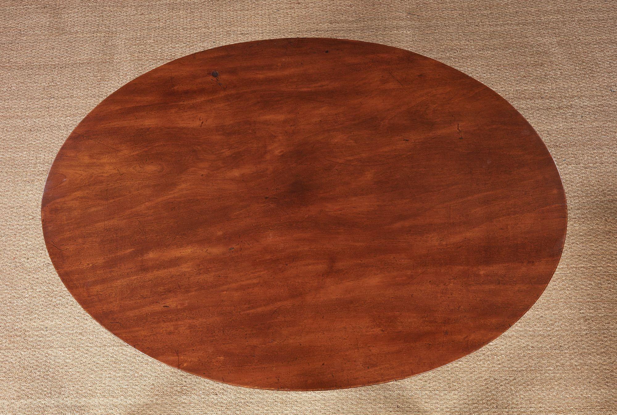 Fine George III mahogany oval breakfast table, the vividly grained top with reeded edge, over turned vasiform shaft and standing on downswept reeded legs ending in original brass toe caps and castors.  Good patina.  Attractive and useful form.

vsz