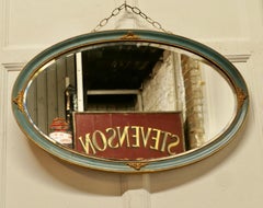 Oval Gilt and Painted Wall Mirror  This Mirror has a moulded oval frame