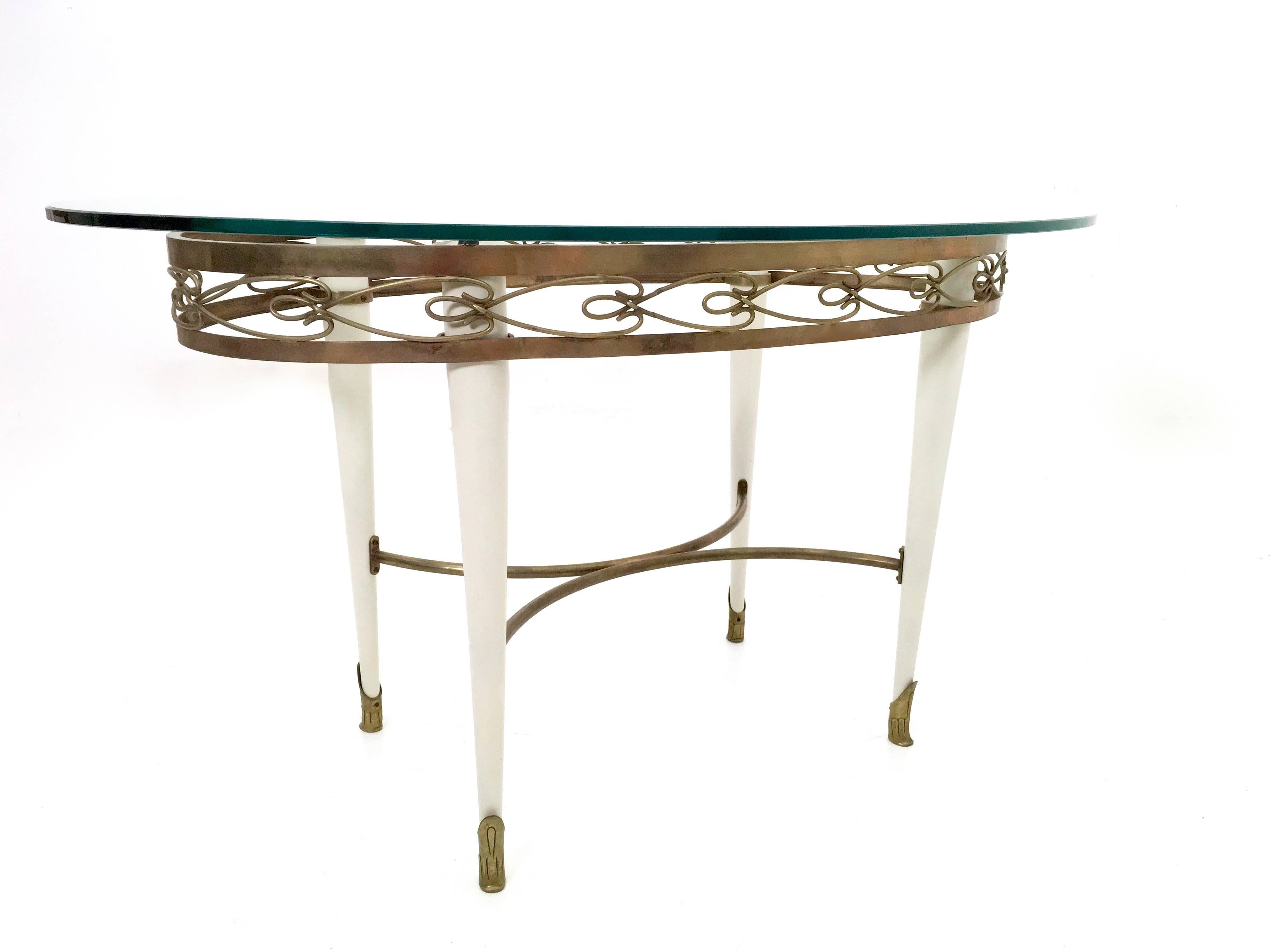 Italian Brass Coffee Table with an Oval Glass Top in the Style of Pierluigi Colli, Italy For Sale