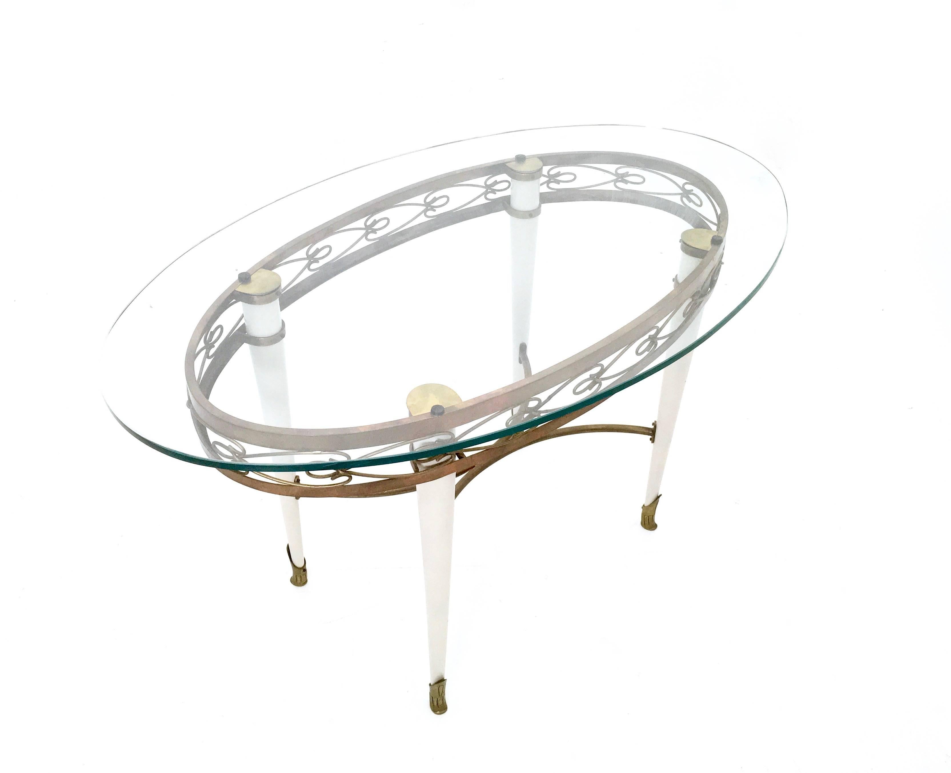 Lacquered Brass Coffee Table with an Oval Glass Top in the Style of Pierluigi Colli, Italy For Sale