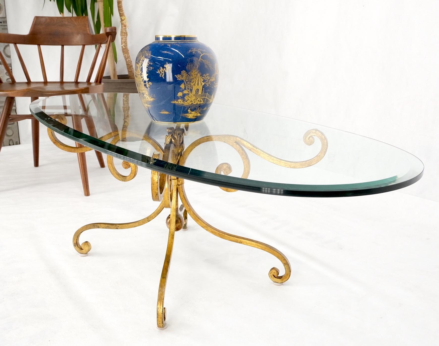 Oval glass gold gilt wrought iron metal base hollywood regency coffee table.