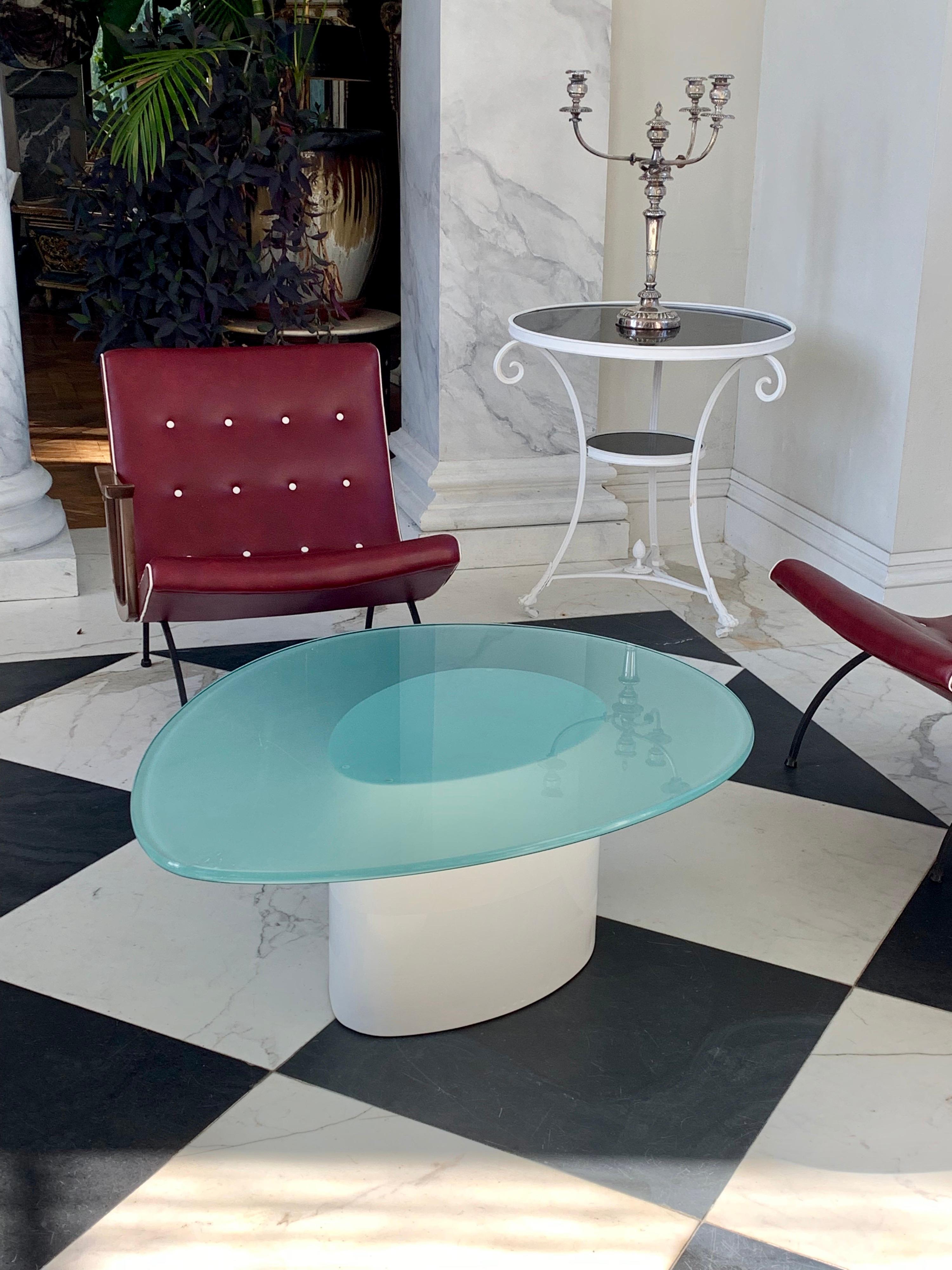 Early 1980s glass top coffee table artistically refinished by our team in 3” layers of shiny and matt textured lacquer over metal,
The original oval glass top is 3/4” thick and frosted on the underside.

  