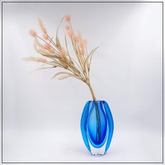 Oval glass vase in shades of blue, in the style of Sommerso