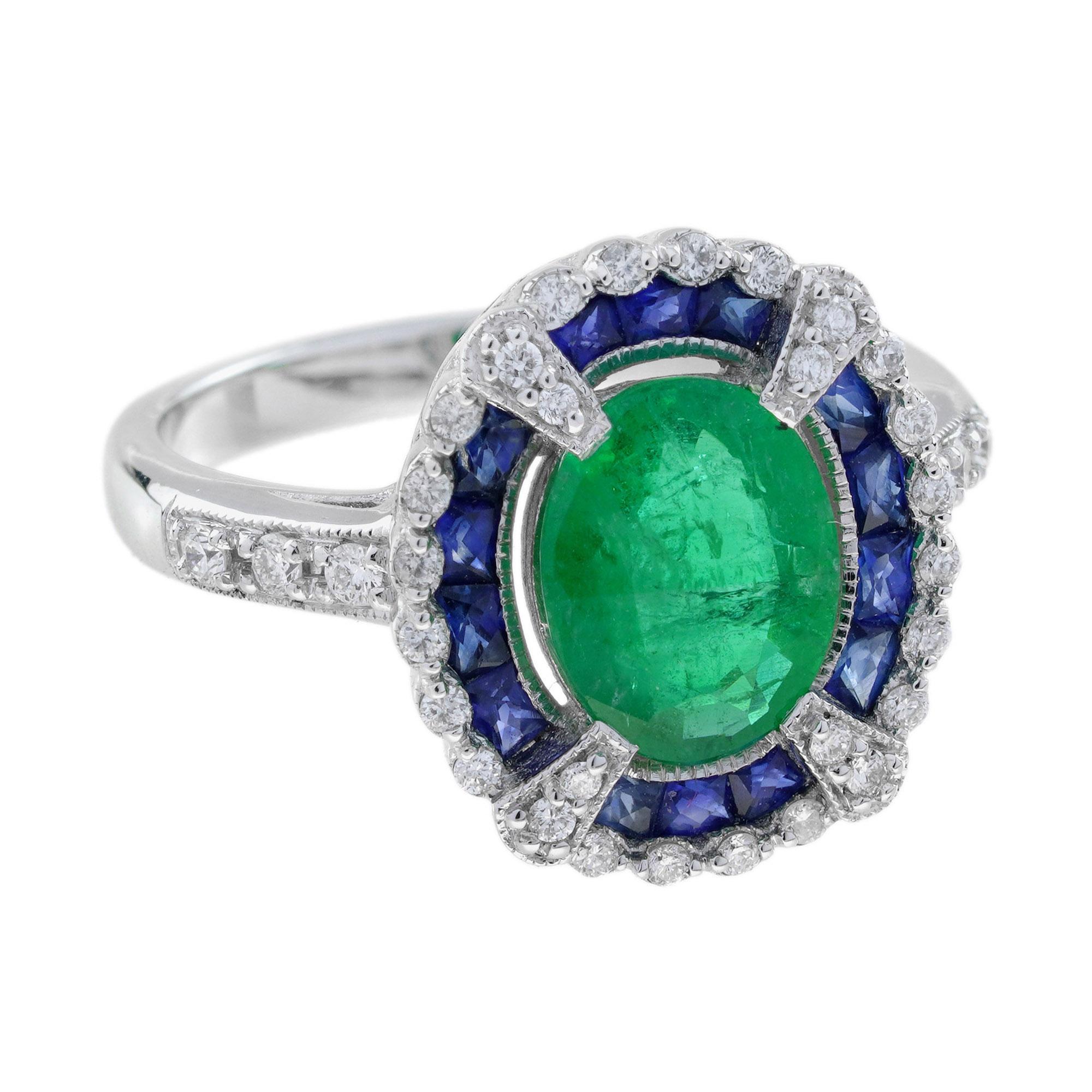 The Emerald, Sapphire, and Diamond Art Deco Style Halo Ring features a vibrant emerald at the center, surrounded by a circular halo of rich sapphires. The outermost frame of the ring is adorned with sparkling diamonds, creating a stunning contrast