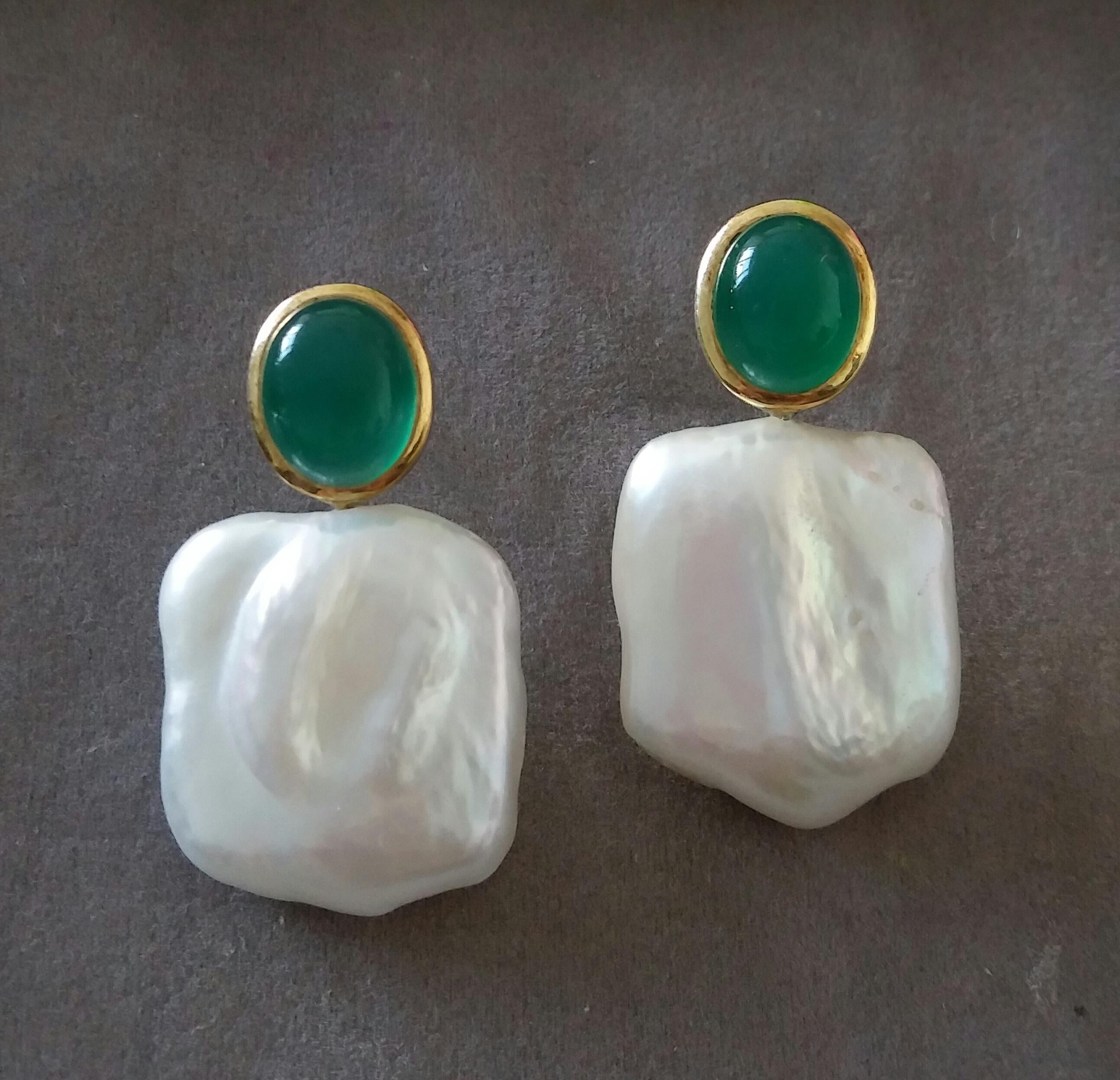 These simple chic and handmade stud earrings have a pair of Oval Shape Natural Green Onyx Cabs measuring 9 x 11 mm set in solid 14 Kt. yellow gold bezel on the top and in the lower parts 2 excellent luster White Square Shape Baroque Pearls measuring