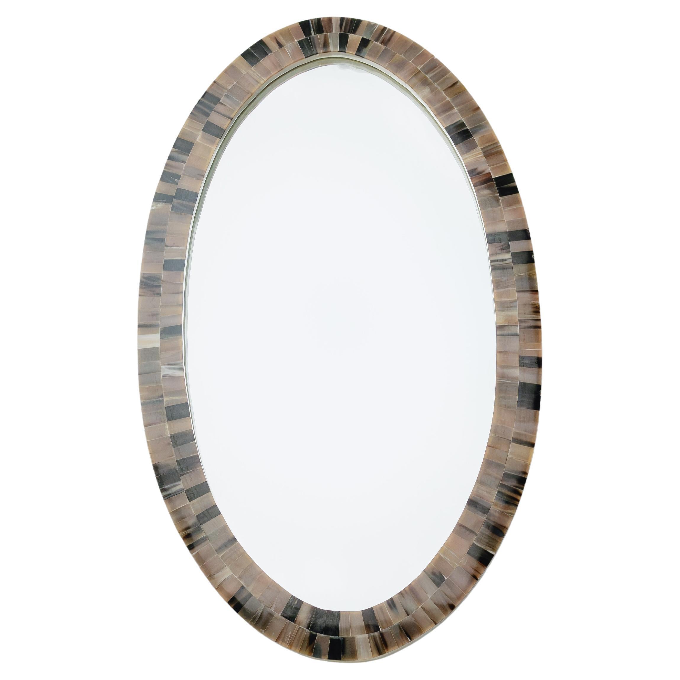Introducing the Orbit, Oval Horn Mirror, a testament to the visionary craftsmanship at Farrago Design. With a perfect oval shape, it grants a versatility to compliment any space, from grand hallways to intimate chambers, with an air of timeless