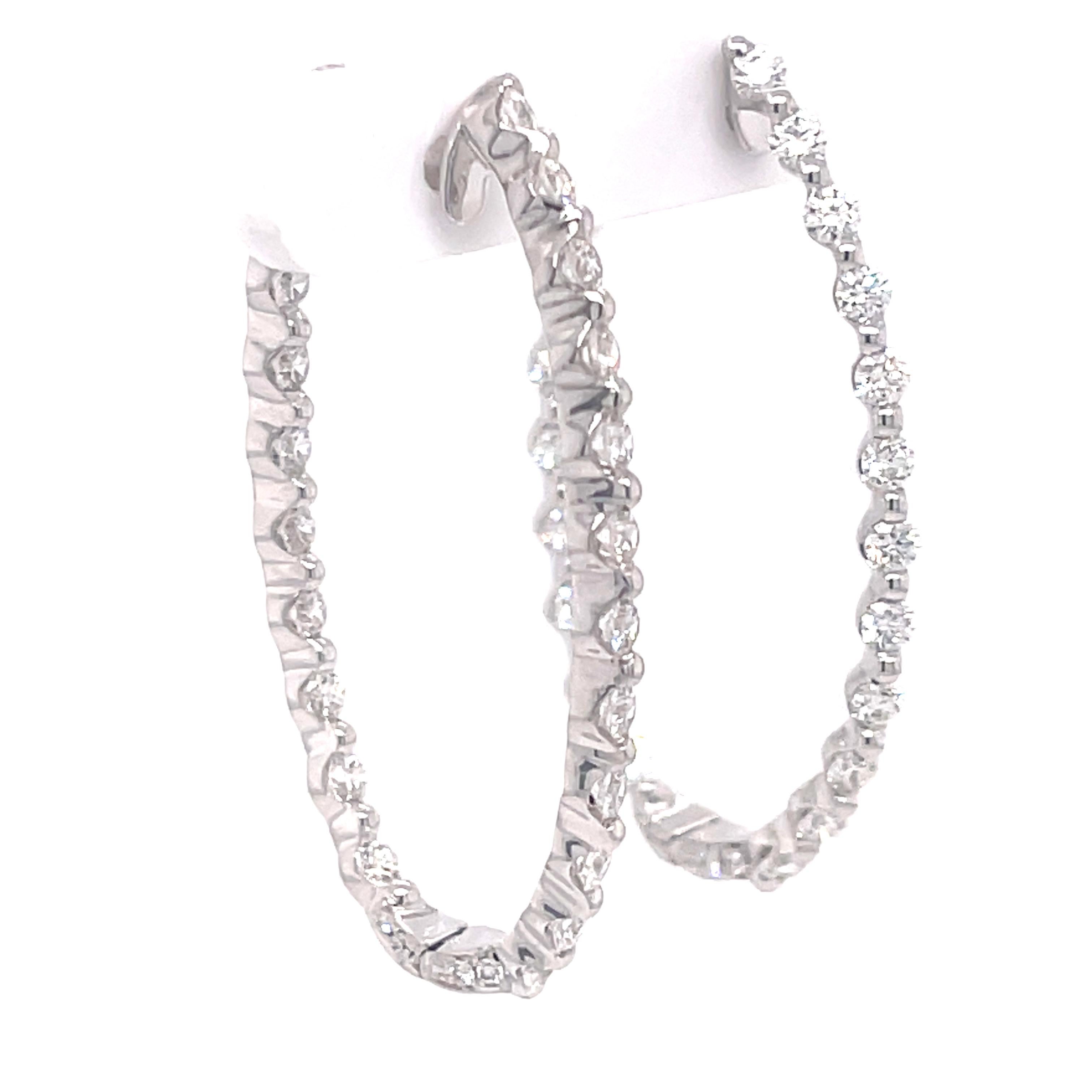Oval inside out diamond hoops in 18K white gold. The hoops feature 2.26ctw of diamonds. 