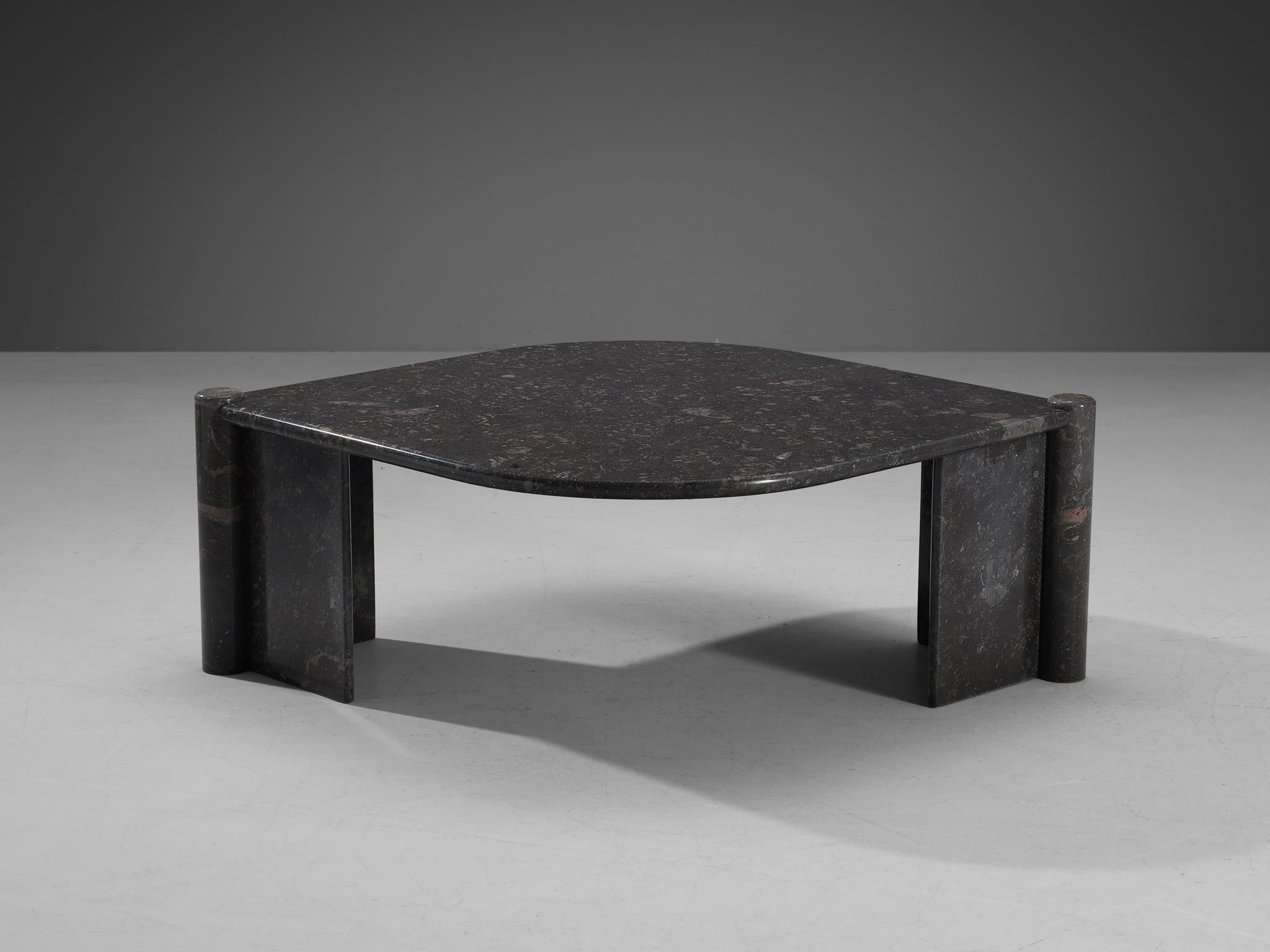 Side table, marble, Italy, 1970s.

This sculptural table has an eye-shaped top and two open triangles that face one another. The circular ends of the base locks the top by means of gravity. The construction is so smoothly designed that everything