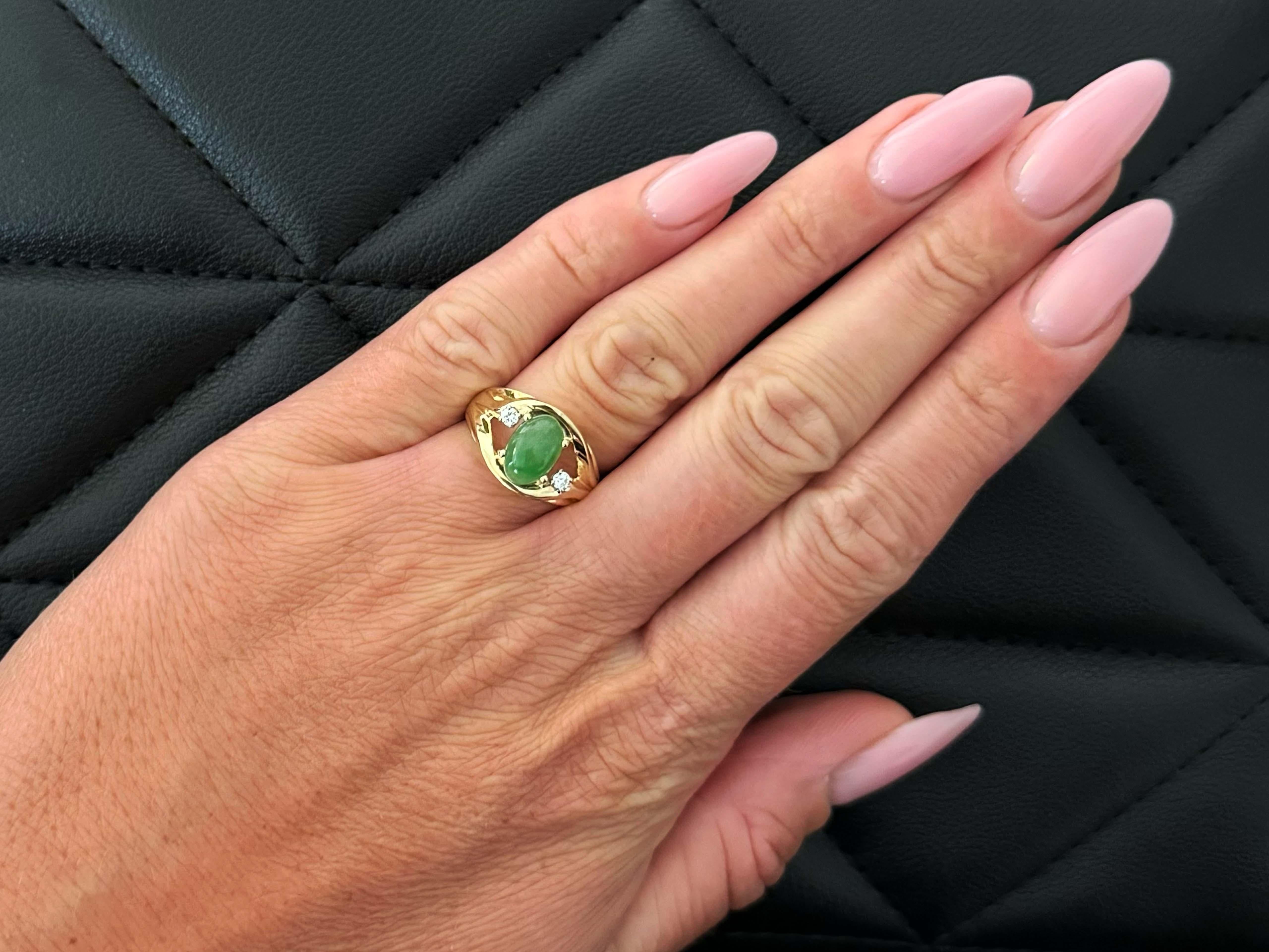 Ring Specifications:

Metal: 14k Yellow Gold

Total Weight: 6.2 Grams

Diamond Count: 2

Diamond Carat Weight: 0.10 carats

Diamond Color: G-I

Diamond Clarity: VS

Jade Carat Weight: ~2.65 carats

Jade Measurements: 9.5 mm x 6.5 mm x 4.8 

Ring