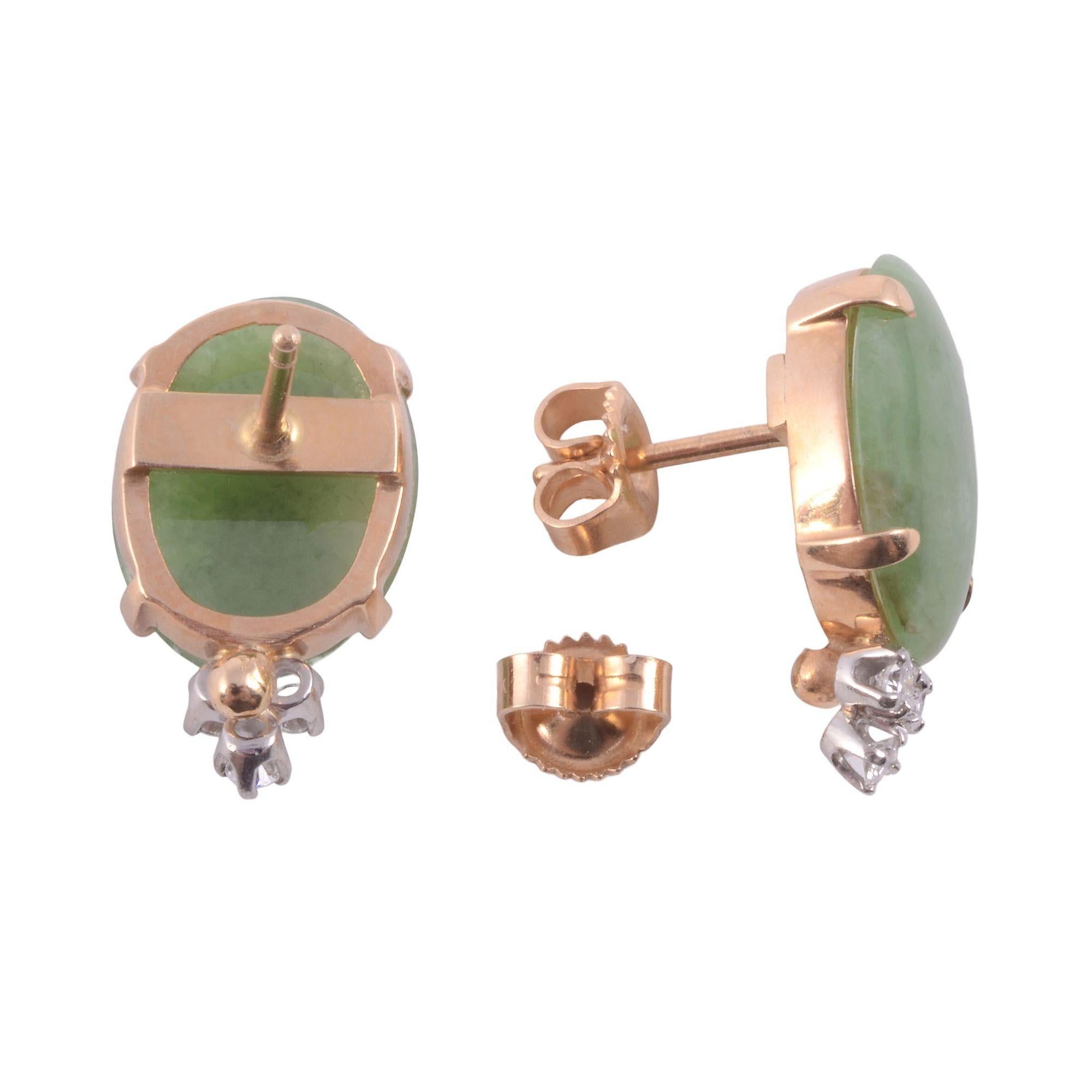 Estate oval jade earrings. These 14 karat yellow gold post earrings feature oval jade accented with round diamonds at .16 carat total weight, G-H in color. [KIMH 532]

Dimensions
19.6mm H overall; jade 14.2mm x 11.2mm