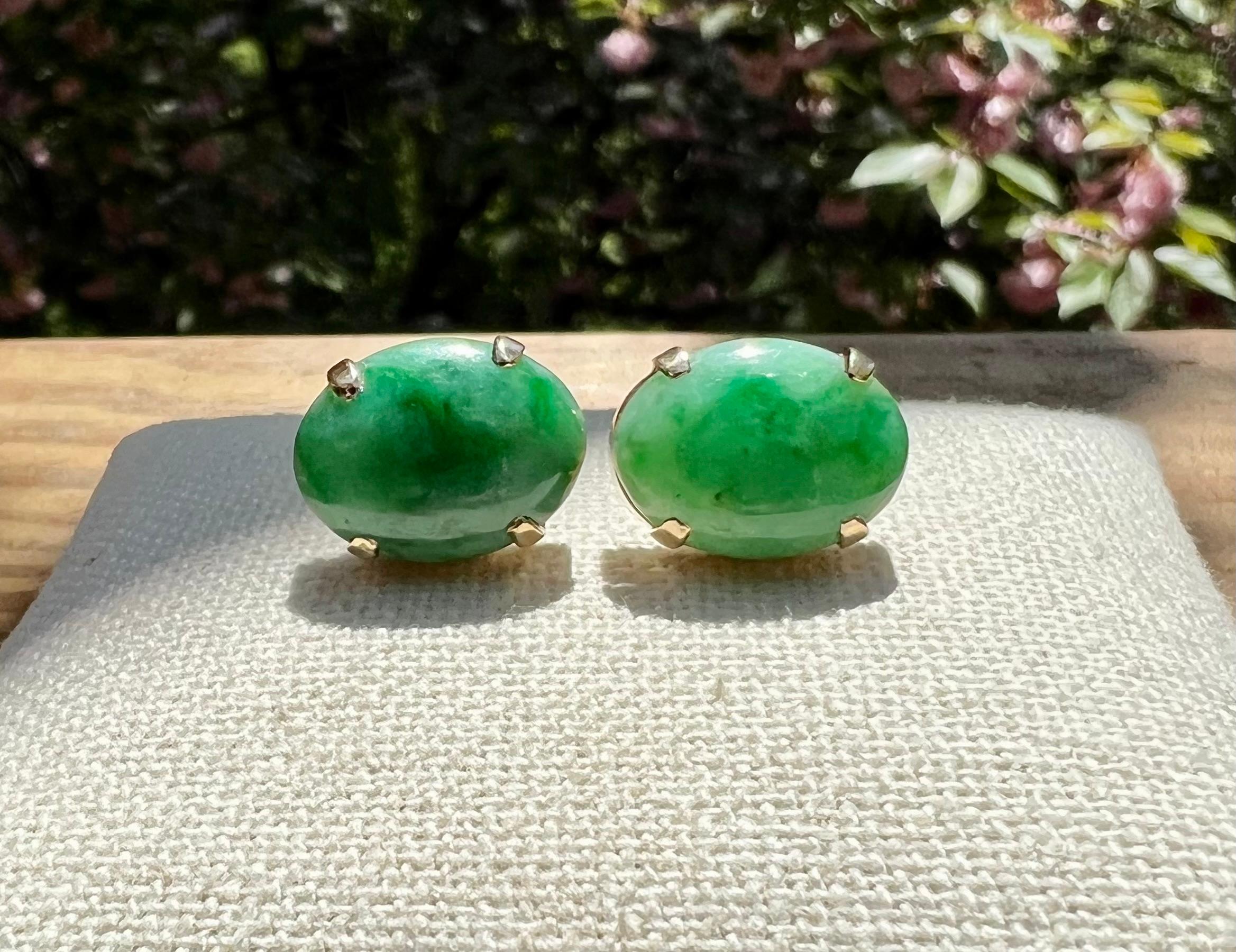 One pair of 14 karat yellow gold (stamped 14K) earrings, each set with one 16 x 12mm oval jade stone.  The earrings are complete with friction posts and backs.  