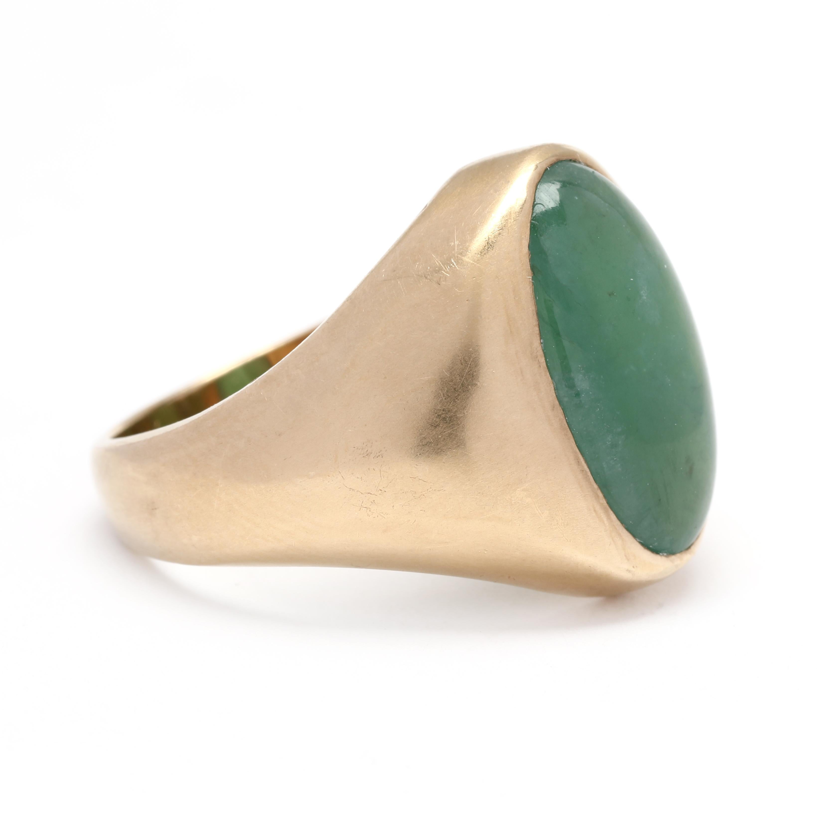 This exquisite and timeless oval jadeite jade signet ring is a show-stopper! The gemstone is a translucent green jadeite jade, and is set with a 14k yellow gold bezel. Its classic, masculine design makes it an ideal ring for a gentleman's wardrobe.