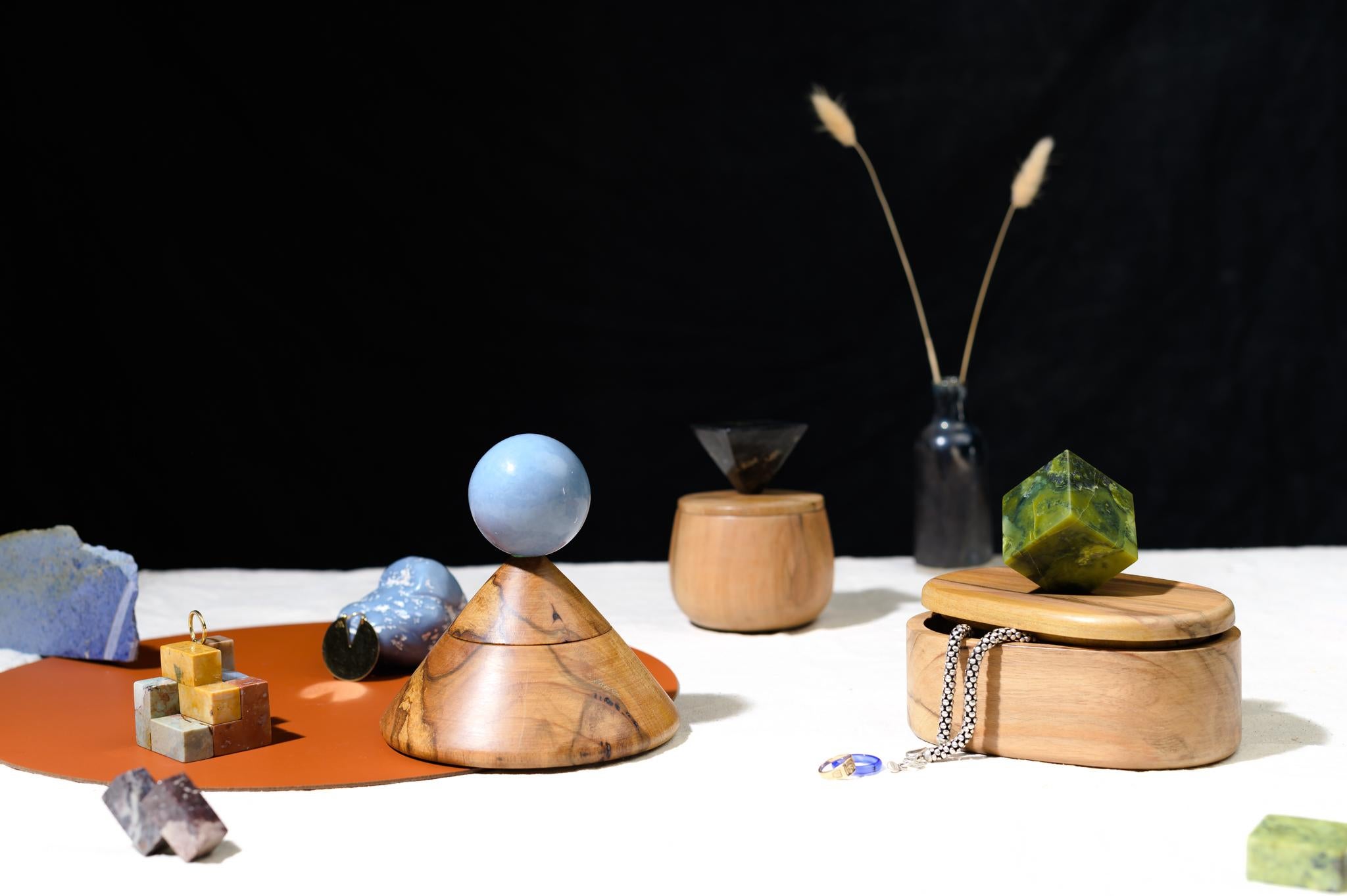 The oval everything box jewelry box is a hand-carved using traditional wood carpentry techniques. The cube-shaped green gem stone handle is a geometric element that offers a playful pause in the day to enjoy the luxurious semi-precious stone