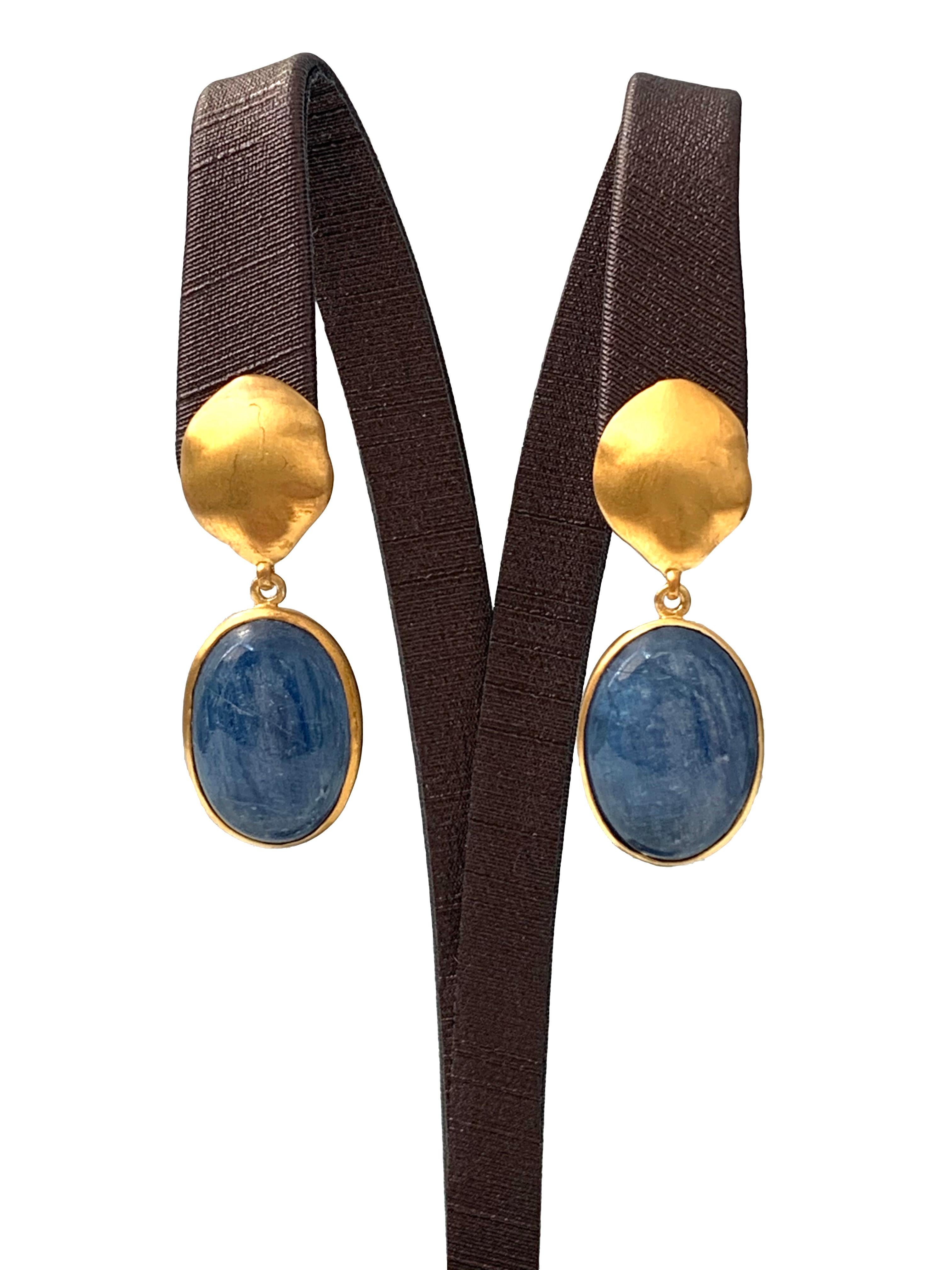 Discover oval Kyanite Vermeil Drop Earrings. The earrings feature 2 large oval cabochon-cut Kyanite with unique and beautiful iridescent blue hue, handcrafted brushed satin texturing technique, and hand set in vermeil 18k gold plated sterling