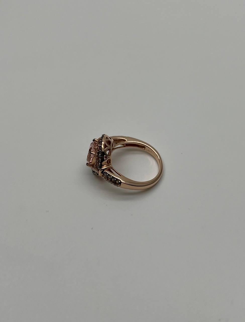 Elegant Multi-Stone Ring. This exquisite ring features a stunning central stone surrounded by a double halo of smaller diamonds, all set in a beautifully crafted band. The intricate design highlights the central gem, enhancing its brilliance. The