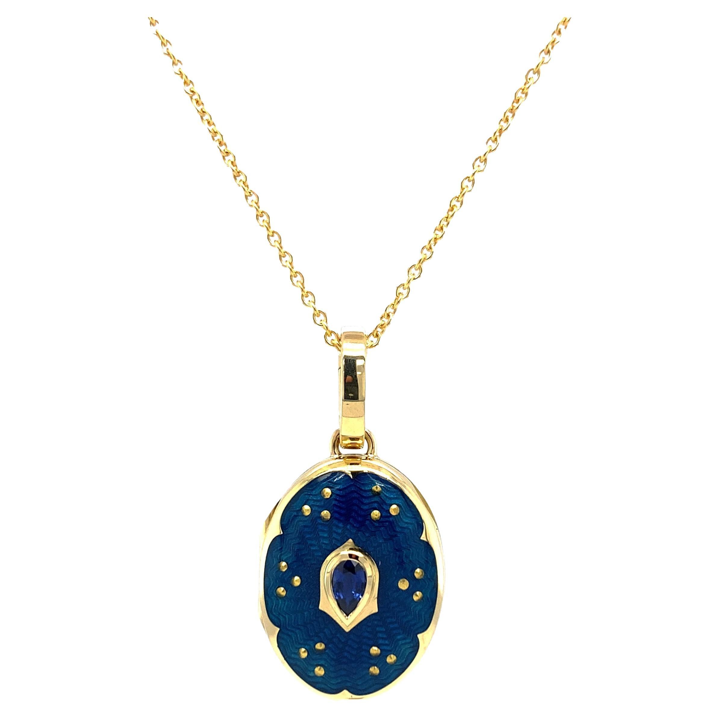 Oval locket pendant necklace, 18k yellow gold, Victoria Collection by Victor Mayer, petrol blue vitreous enamel with paillon inlays, 1 facetted pear shaped sapphire, measurements app. 20.0 mm x 15.0 mm, 45 cmm. 

About the creator Victor