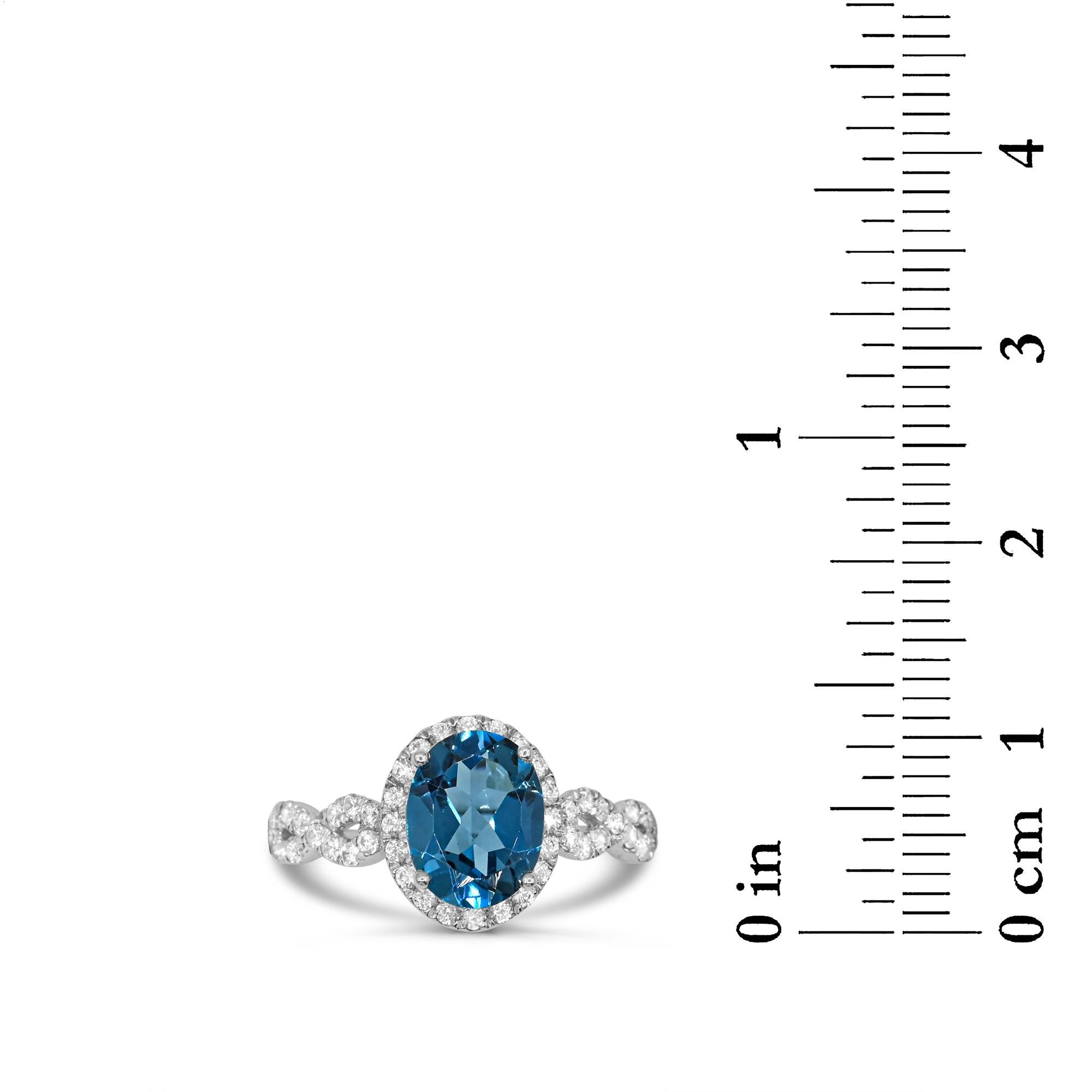 Contemporary Oval London Blue Topaz with White Zircon Halo infinity ring in 10K White Gold For Sale