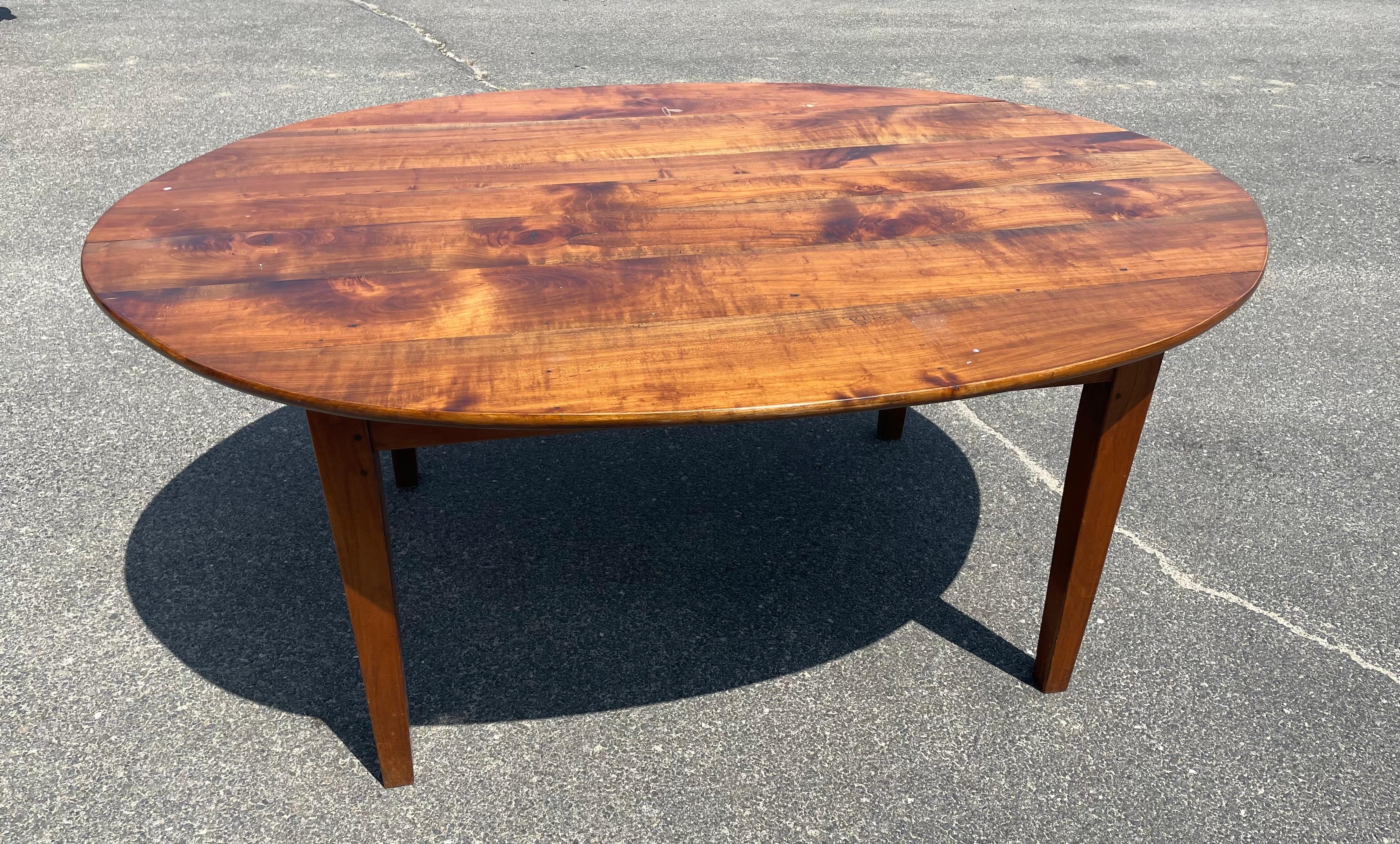 Oval Mahogany farm table with single drawer along one side, on taper legs.