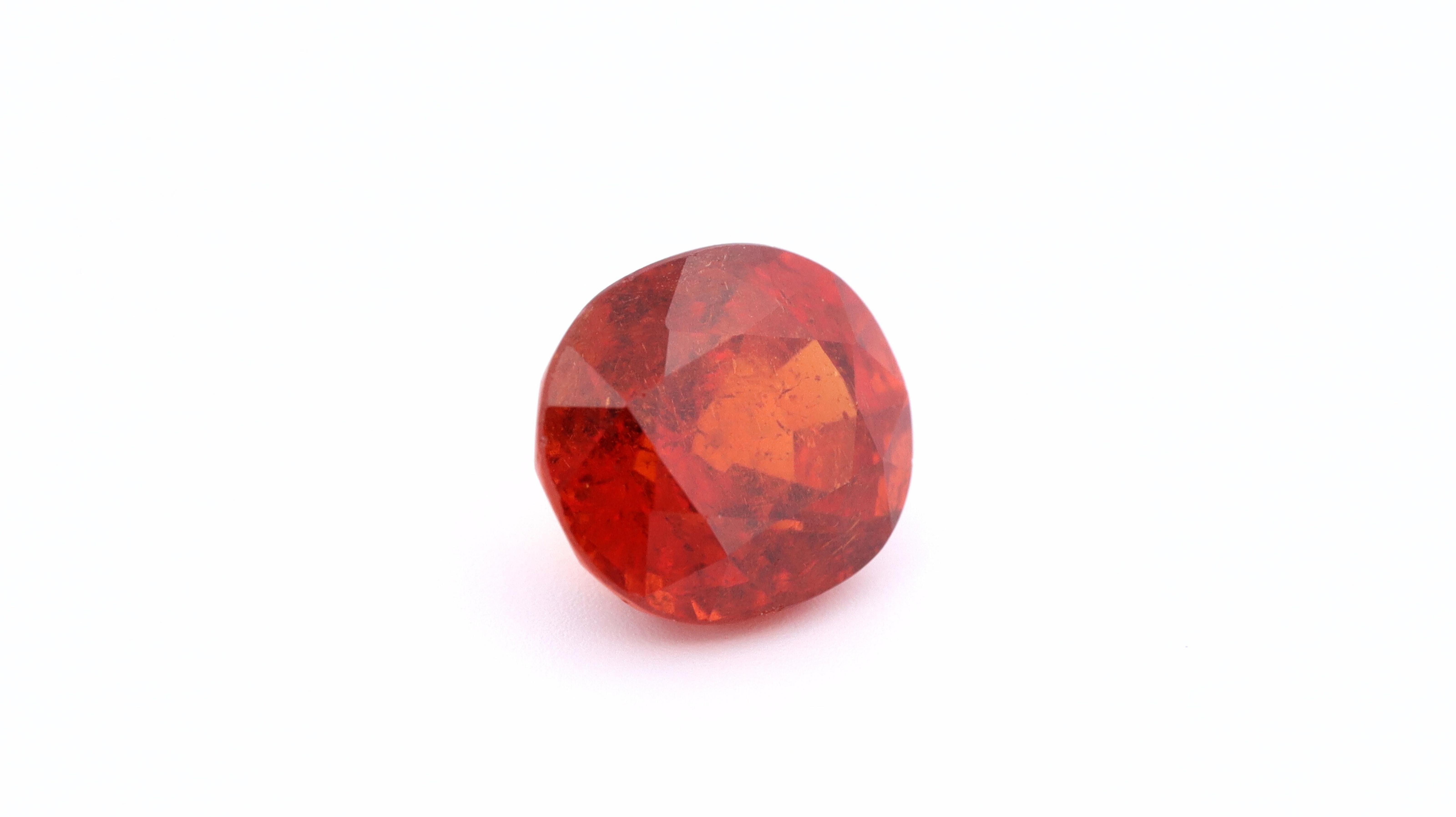 A natural Spessartine Garnet also known as Mandarin Garnet.

There are two well known varieties of orange garnets, Hessonite, which tends to be readily available and less hard, and Spessartine garnet, as this stone, which is rare and highly desired