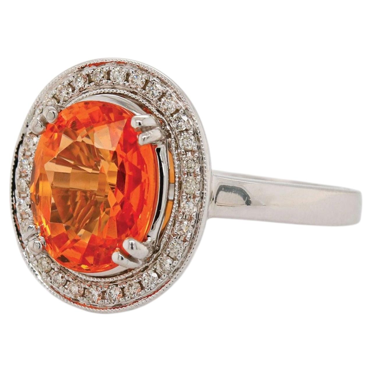 Oval Mandarin Orange Garnet and Diamond Halo Ring