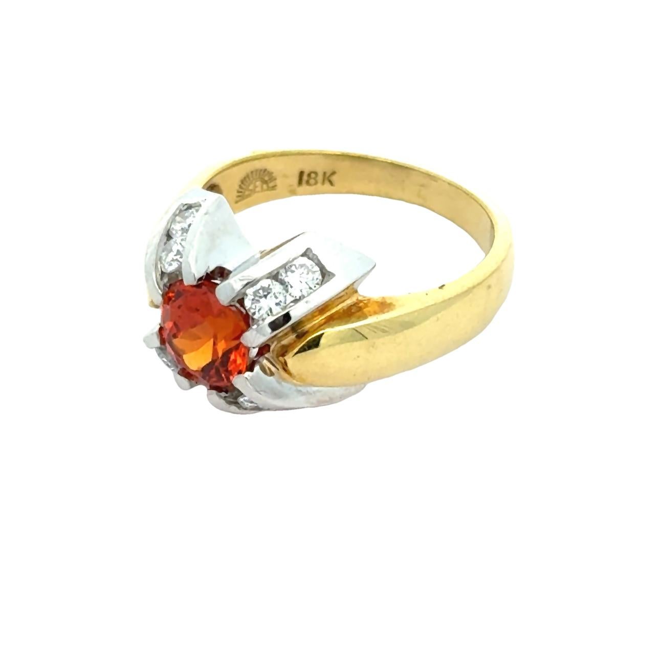 Elevate your style with our Oval Mandarin Orange Garnet and Diamonds in 18K Gold Cocktail Ring. The vibrant round mandarin orange garnet adds a unique touch to this two tone 18K gold ring, while the sparkling diamonds add a touch of elegance. Stand