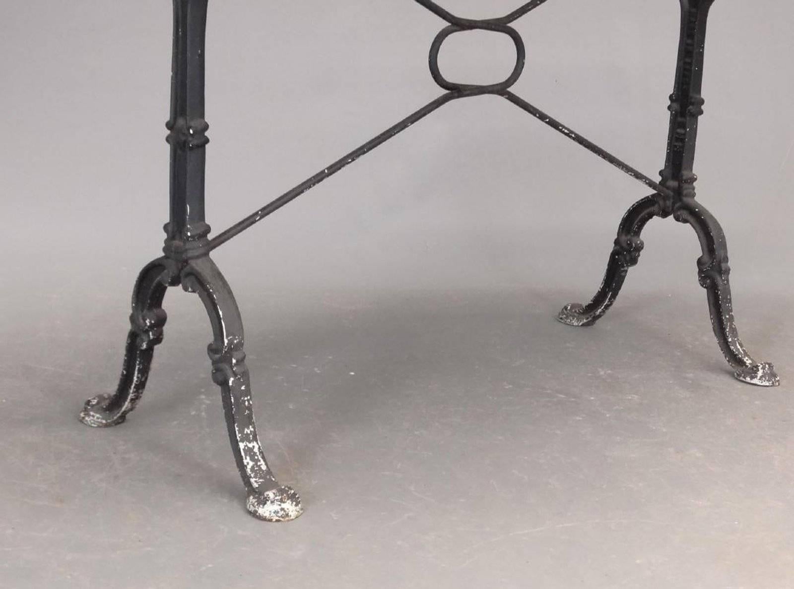 Indoor or outdoor French oval marble top table with wrought iron base. Marble is removable. Can be wonderful on a patio, porch or breakfast kitchen table.
Iron base shows paint loss.
 