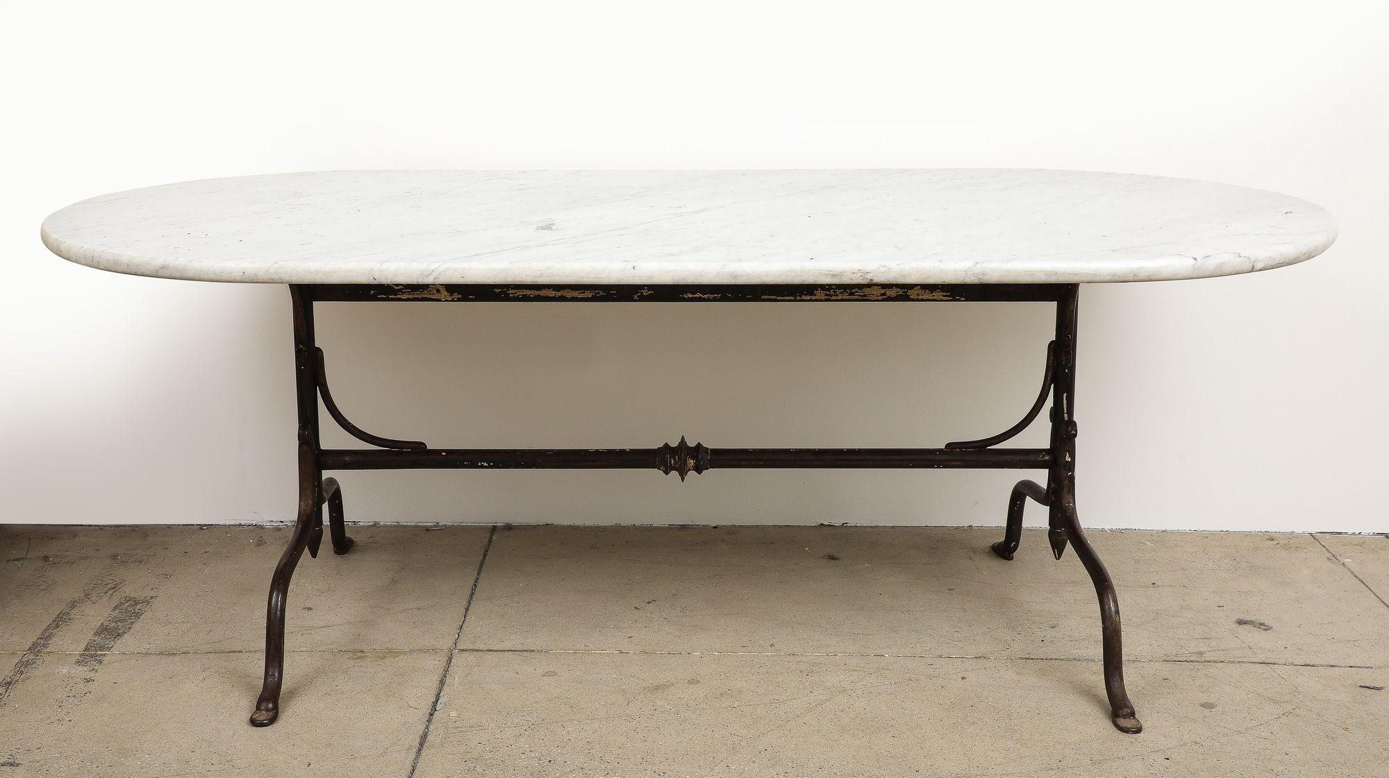 French Oval Marble Topped Dining Table with Trestle Iron Base, France mid 20th c For Sale