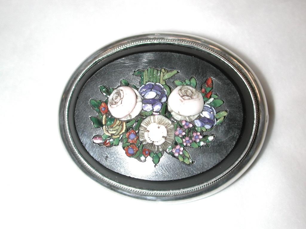 Victorian Oval Micro-Mosaic Brooch Mounted in Silver,dated circa 1880
English Silver brooch with Italian micro-mosaic on black onyx.
It has a fitting at the back for a photo or hair.
Micro mosaics, are a special form of mosaic that uses unusually