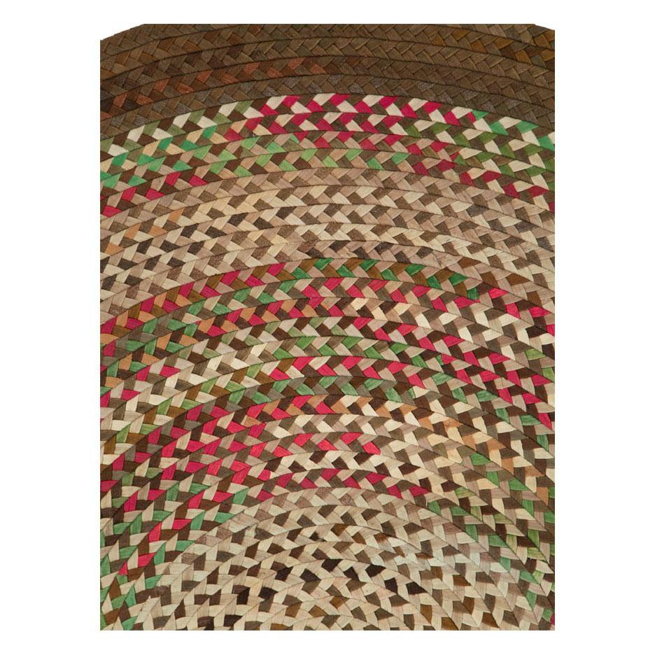 A vintage American Braided oval room size carpet handmade during the mid-20th century.

Measures: 9' 5