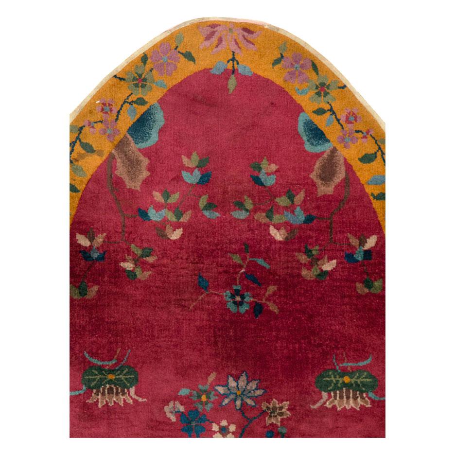 Chinesischer Art-Déco-Teppich in länglicher, ovaler Form, handgefertigt in der Mitte des 20. Jahrhunderts, mit einem Blumenmuster auf einem magentarotfarbenen Feld und einer goldgelben Bordüre.

Maße: 3' 8