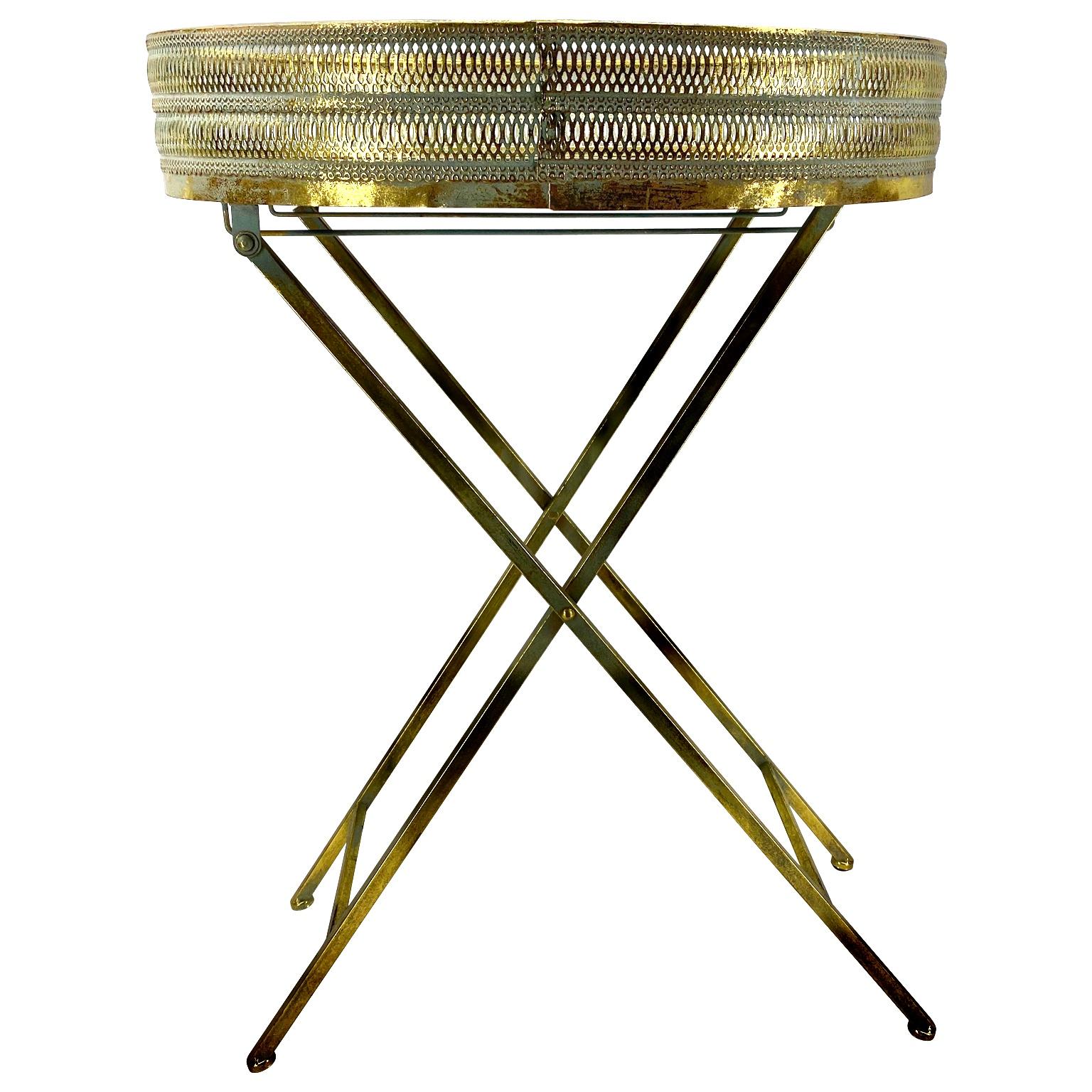 Small oval Mid-Century Modern end table with fine brass mesh gallery.
The table is easily collapsable.