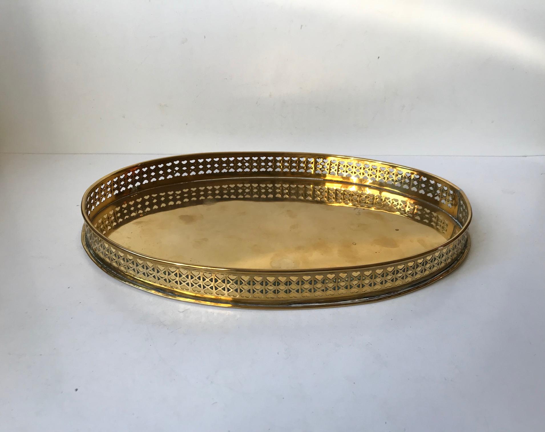 A Danish tray fashioned from partially heart-perforated brass. It was made by Jacob Worm during the late 1960s in a style reminiscent of Josef Frank. It is suitable for serving drinks or as a 1-2 person breakfast tray.